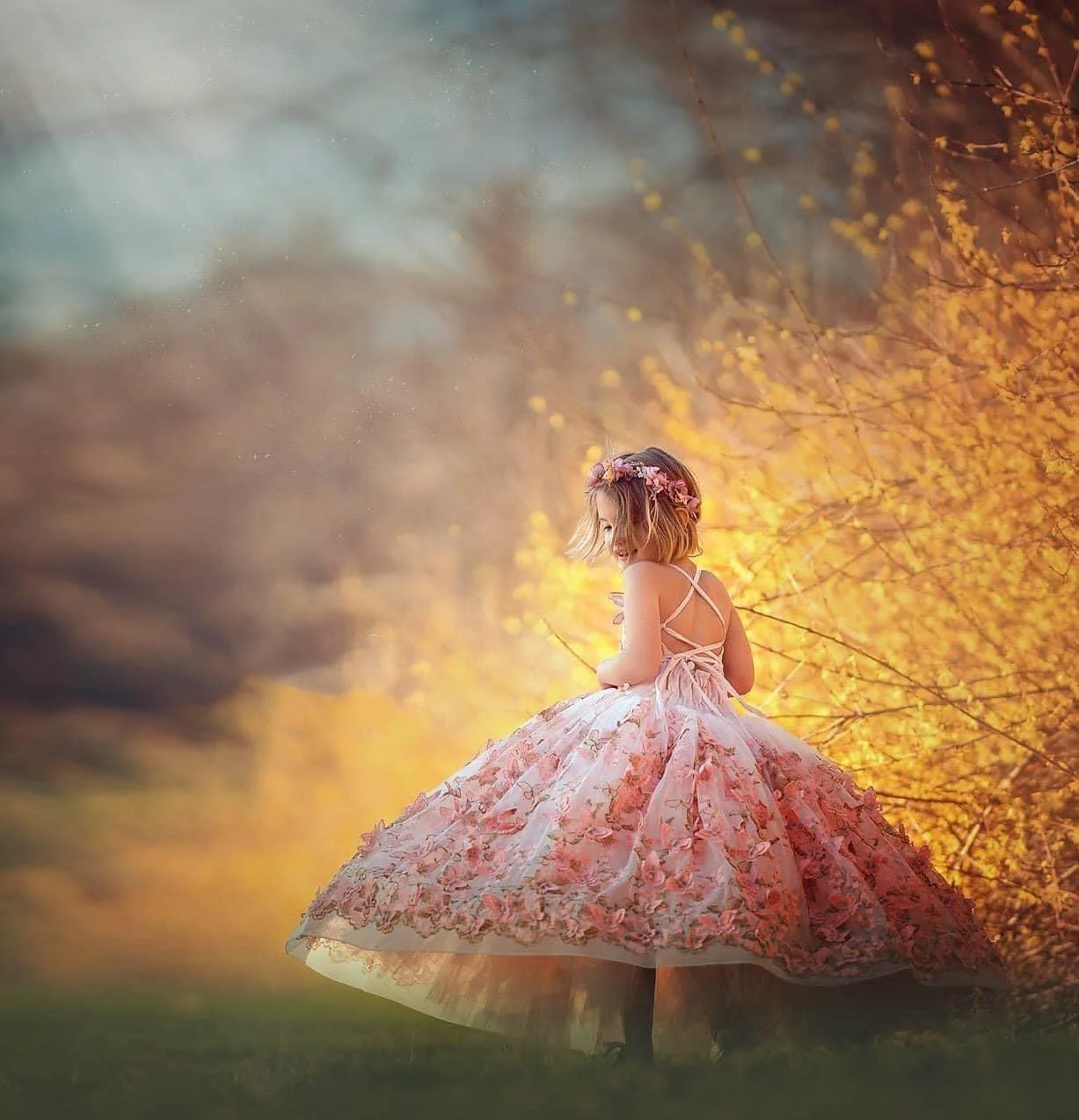 girl twirling in Mullica Hil NJ among forsythia.