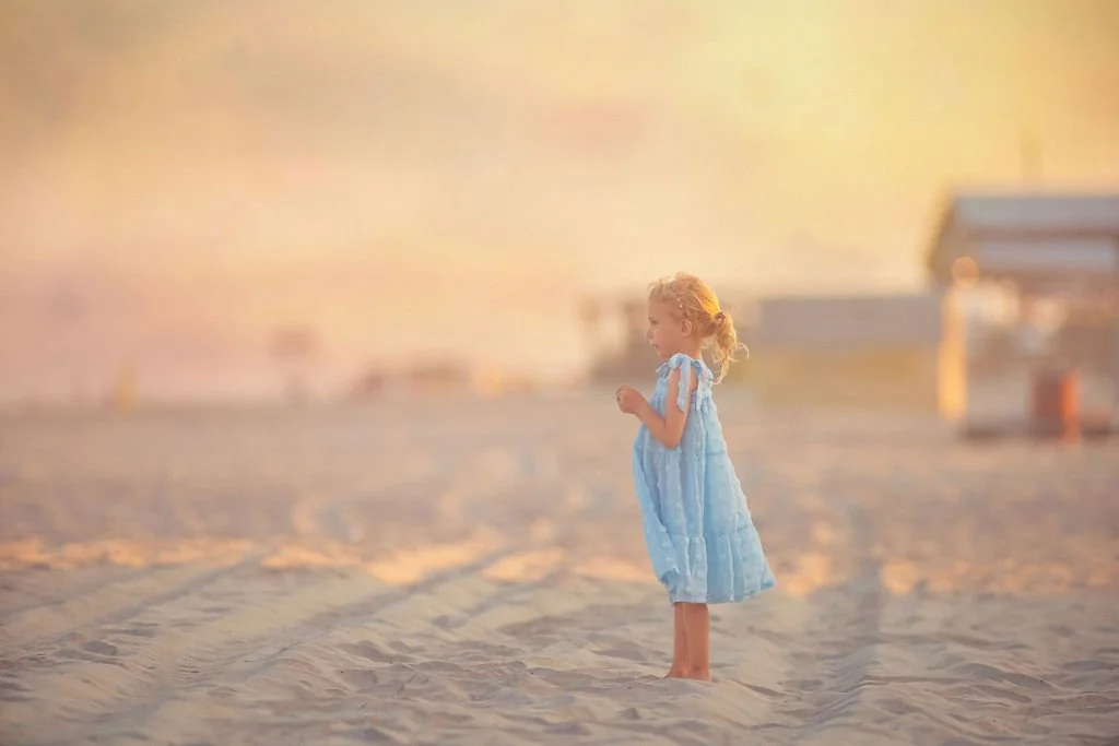 girl standing on the edge of the beach in wildwood new jersey