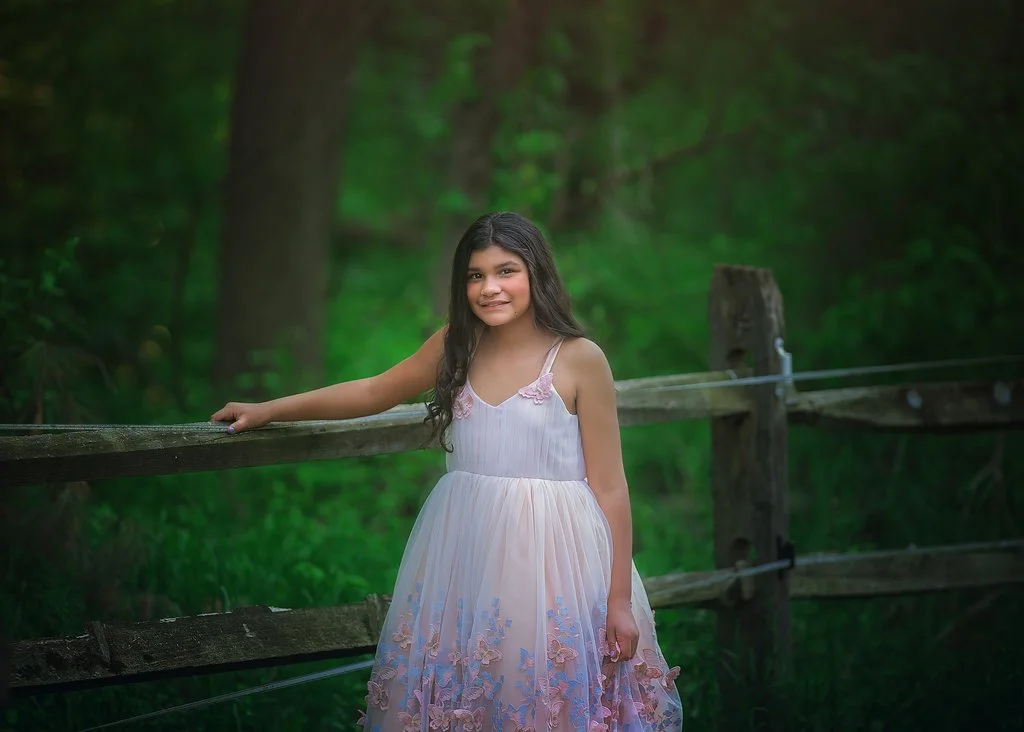 Closeup of a birthday girl in a butterfly dress during a children’s portrait session in Mullica Hill NJ captured by a New Jersey photographer.