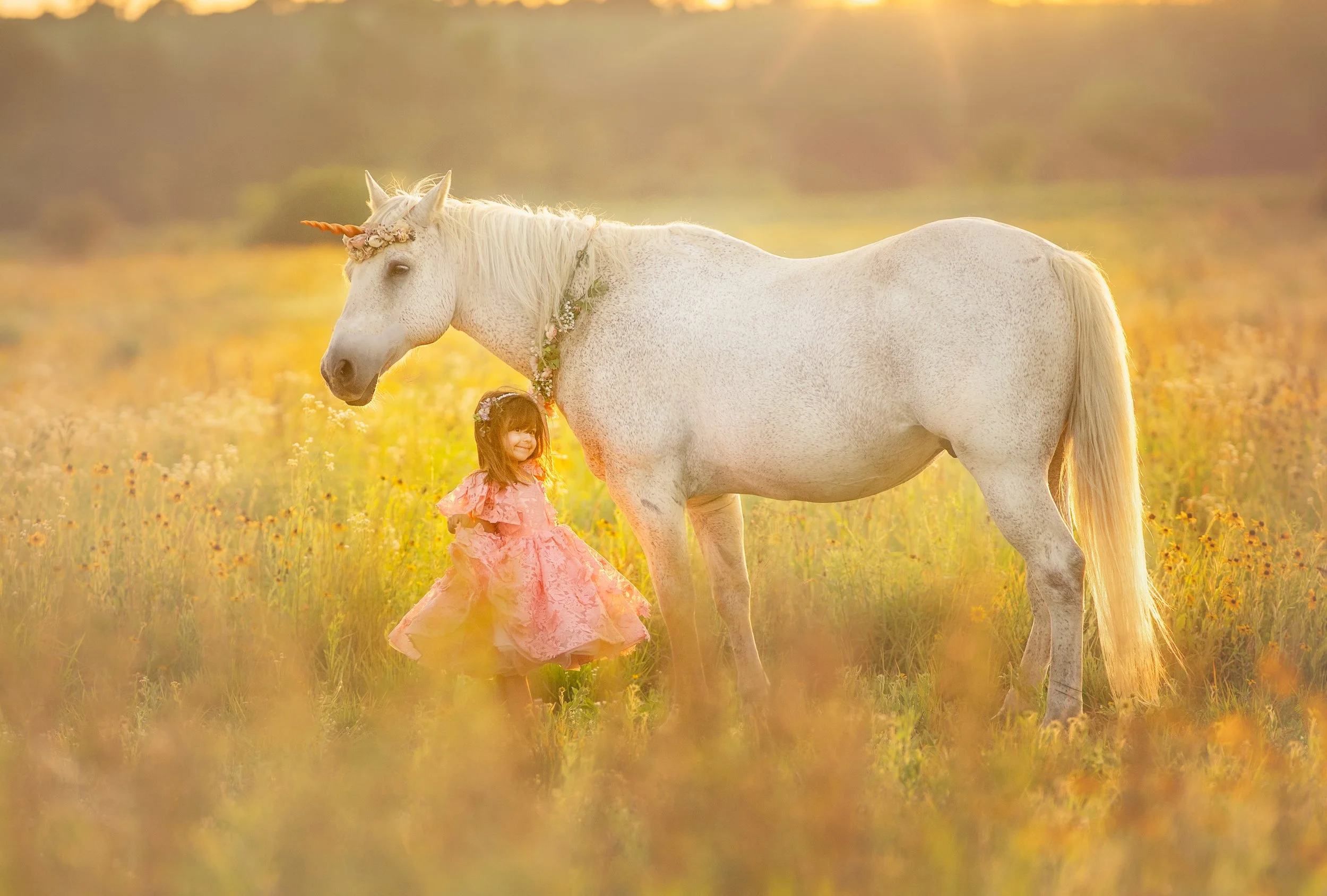child portrait with unicorn in wildflower field at sunset in South Jersey