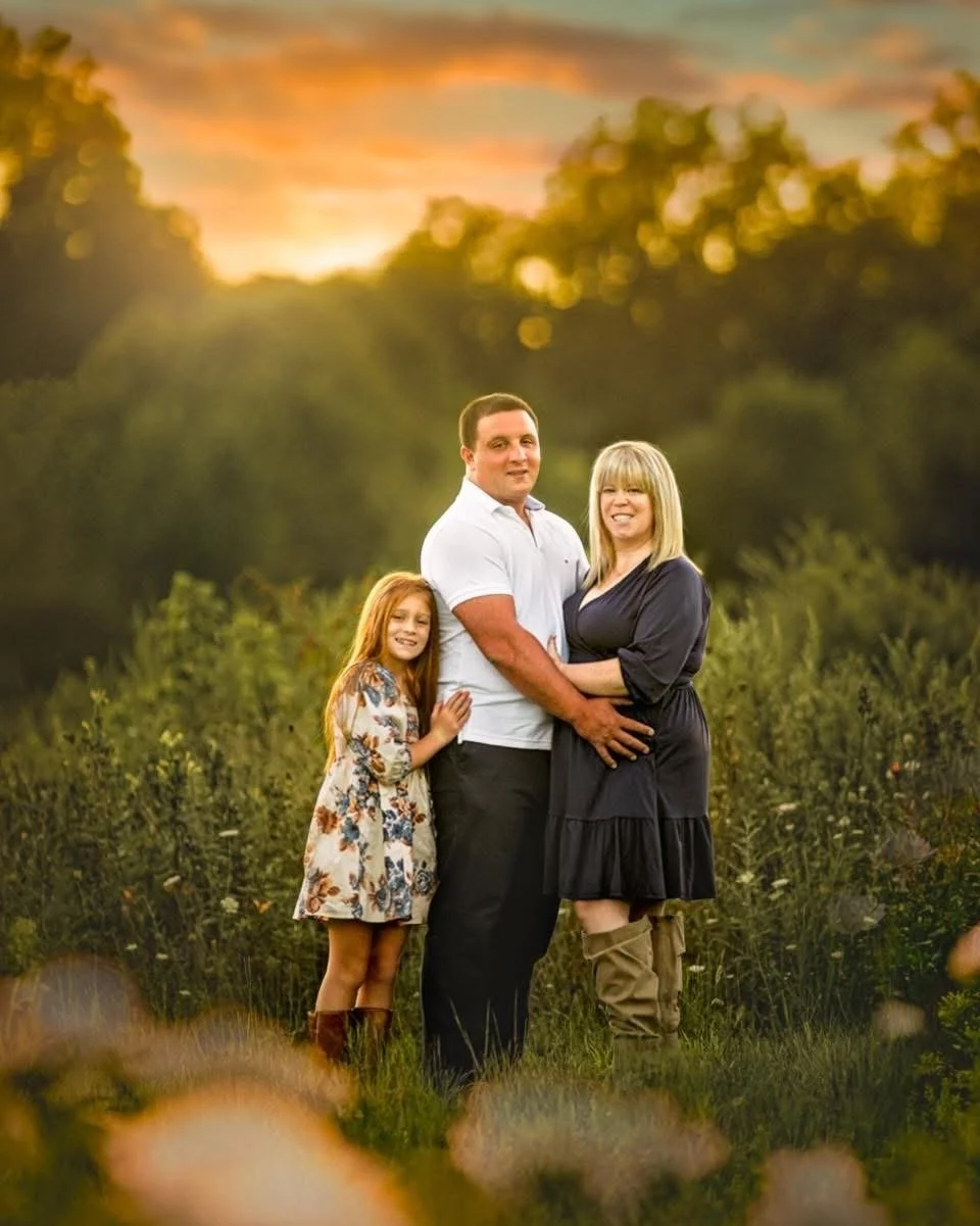Natural family portrait ina lush green outdoor setting with soft light and relaxed, timeless styling.