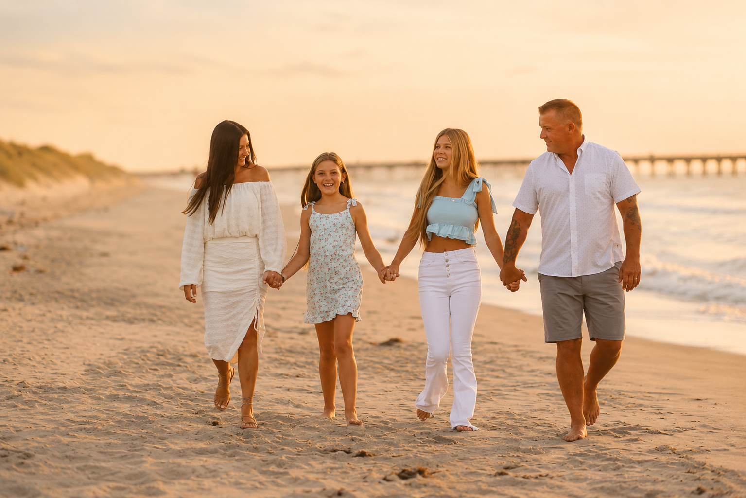 Family walking together along the shoreline during a sunset beach photography session in Ocean City, New Jersey.