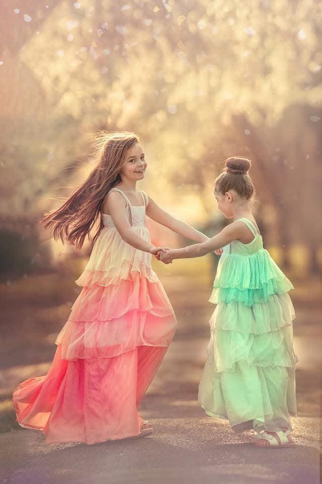 Two sisters standing together in beautiful natural light during a princess portrait session in Fairmount Park, Philadelphia