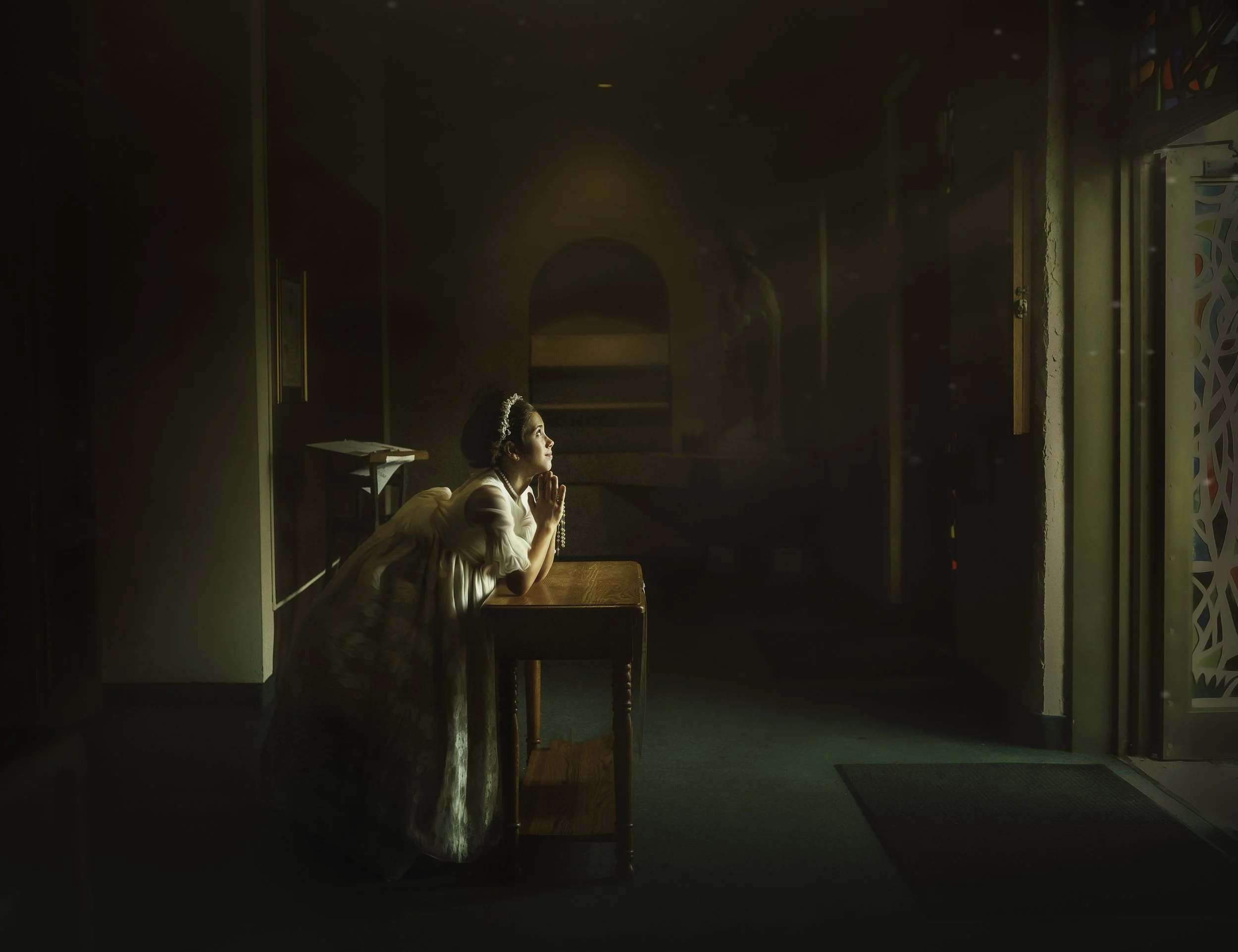 A young girl stands gracefully inside a church in Ocean City, New Jersey during her First Holy Communion portrait session, wearing a traditional white communion dress and veil in soft natural light.