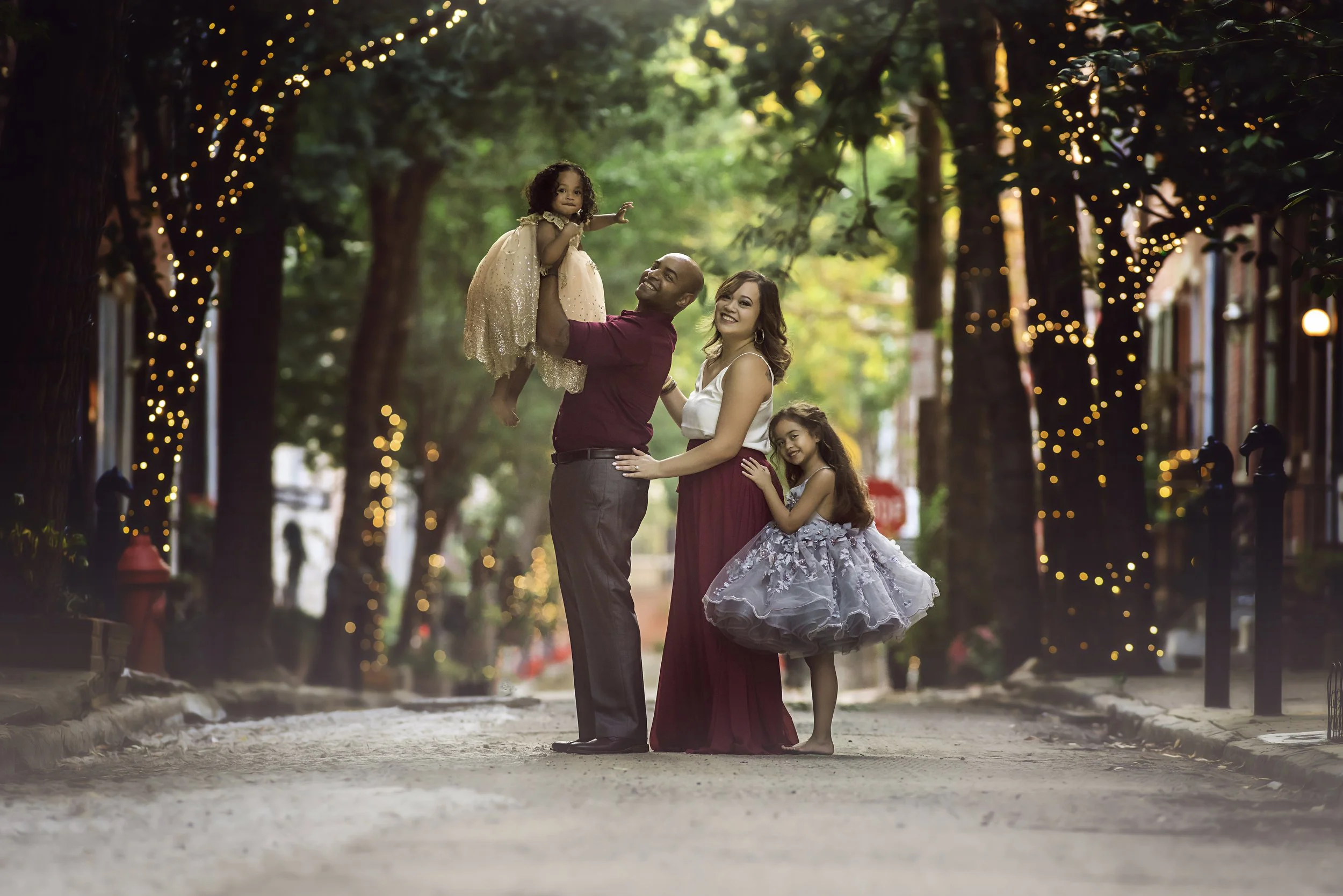 Young family photographed together in Rittenhouse Square during a fine art portrait session.