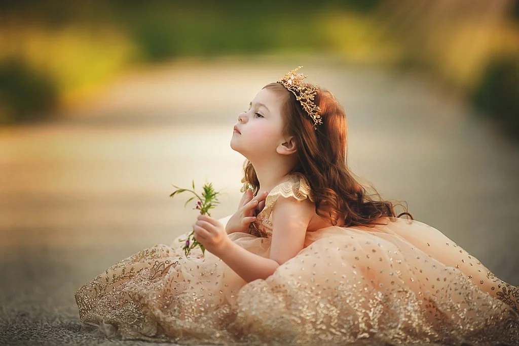 toddler girl wearing gold couture dress during portrait session in Sewell New Jersey
