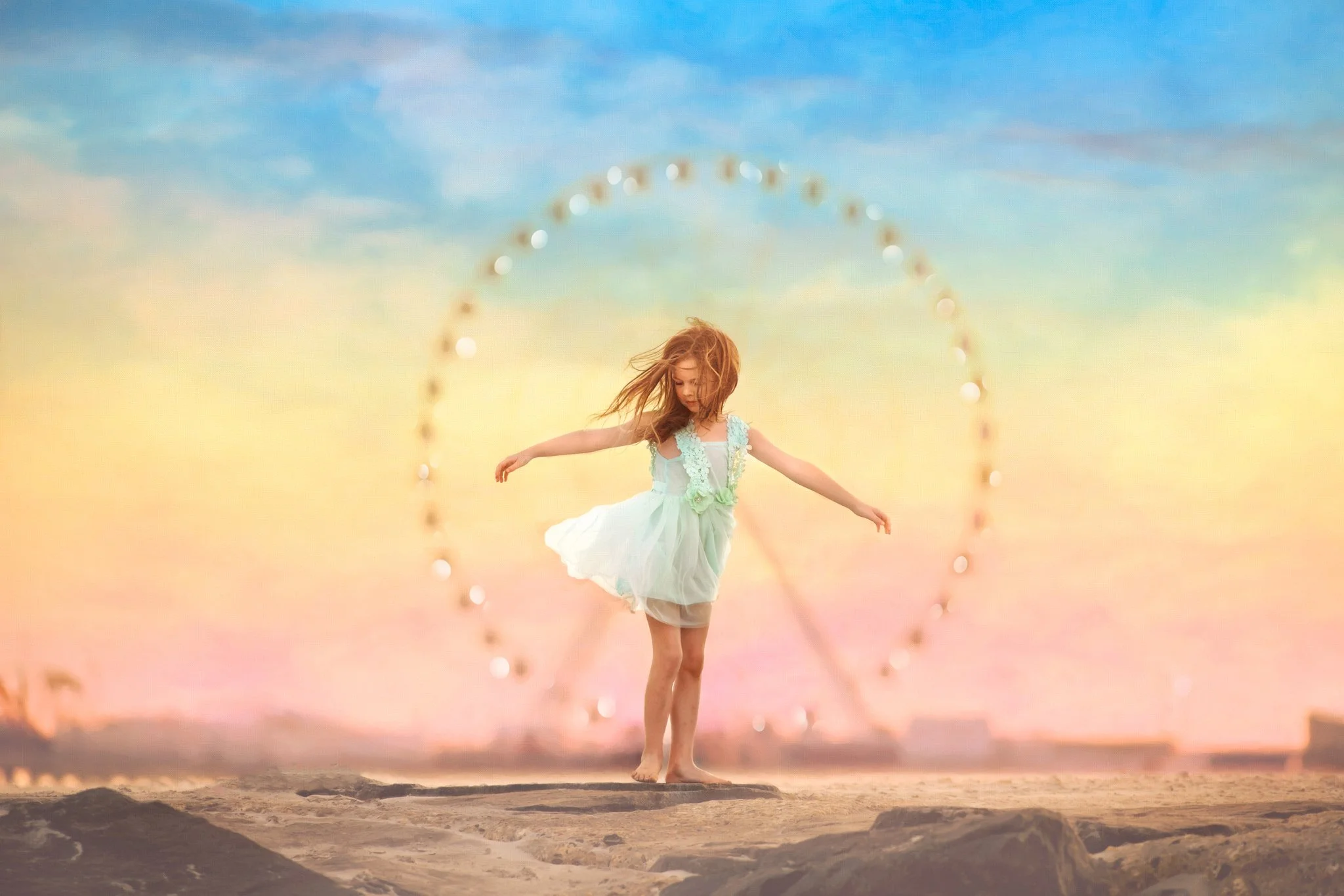 Girl in a mint dress standing along the Atlantic City boardwalk with the Ferris wheel behind her during a Jersey Shore portrait session