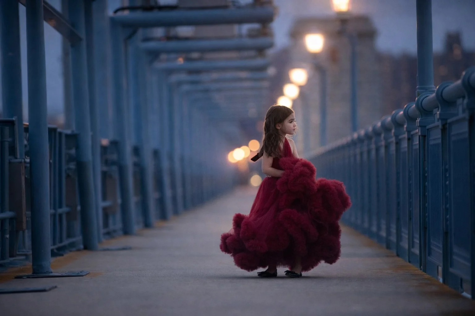 Child portrait of a girl in a red dress with city lights at dusk in Philadelphia