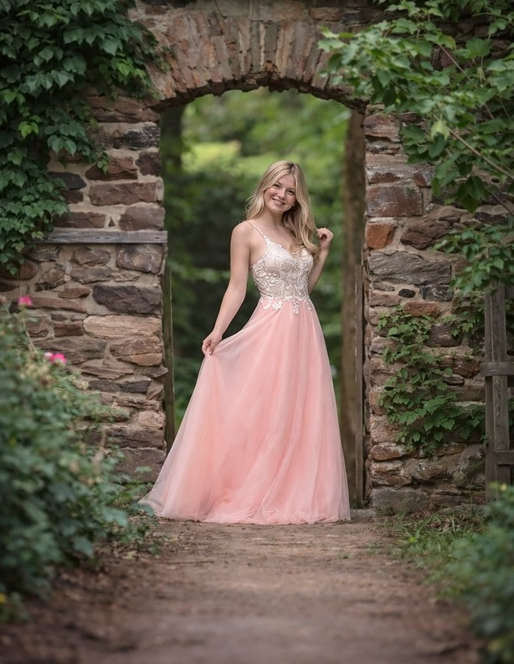 high school senior girl standing under garden archway during portrait session with South Jersey senior photographer near Philadelphia