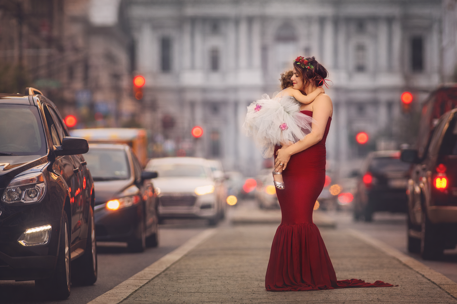A tender motherhood moment during a Philadelphia maternity photography session, featuring a mother holding her young daughter while expecting, photographed in a natural and emotional fine art style.
