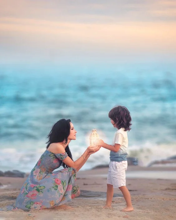 Parent and child sharing a quiet moment by the ocean during a Jersey Shore portrait session