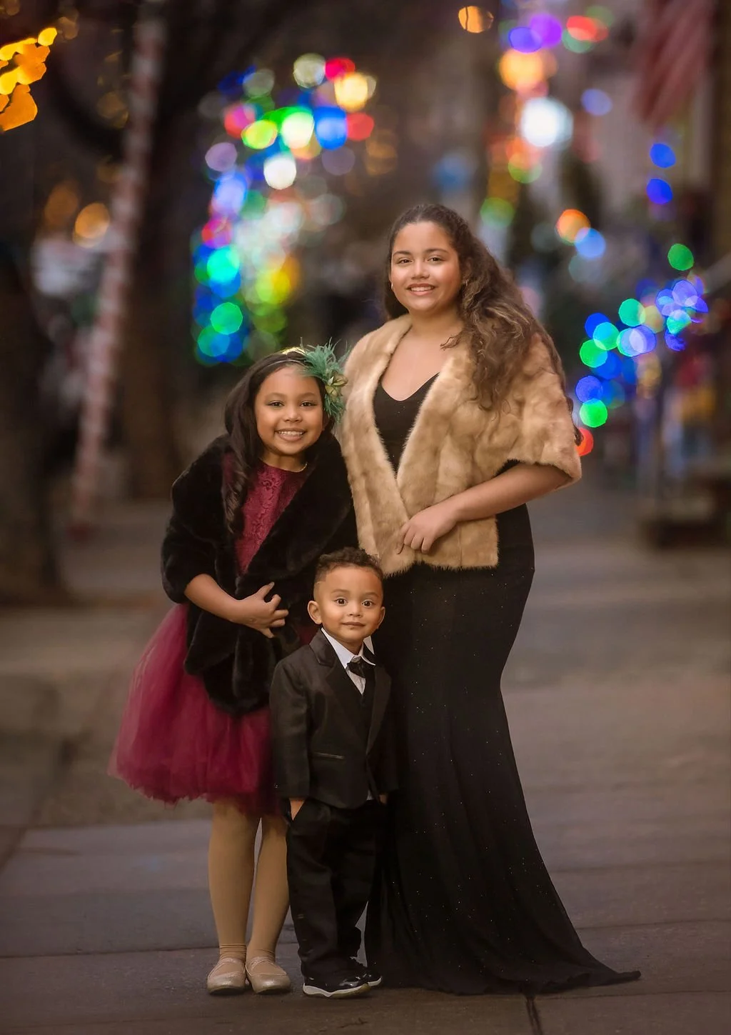 siblings smiling together during a Christmas portrait session in Philadelphia