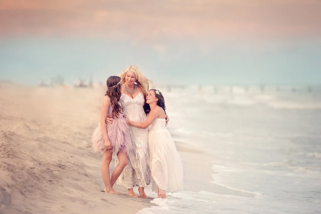Mother with her two daughters on the beach during a South Jersey family photography session under soft pastel evening skies