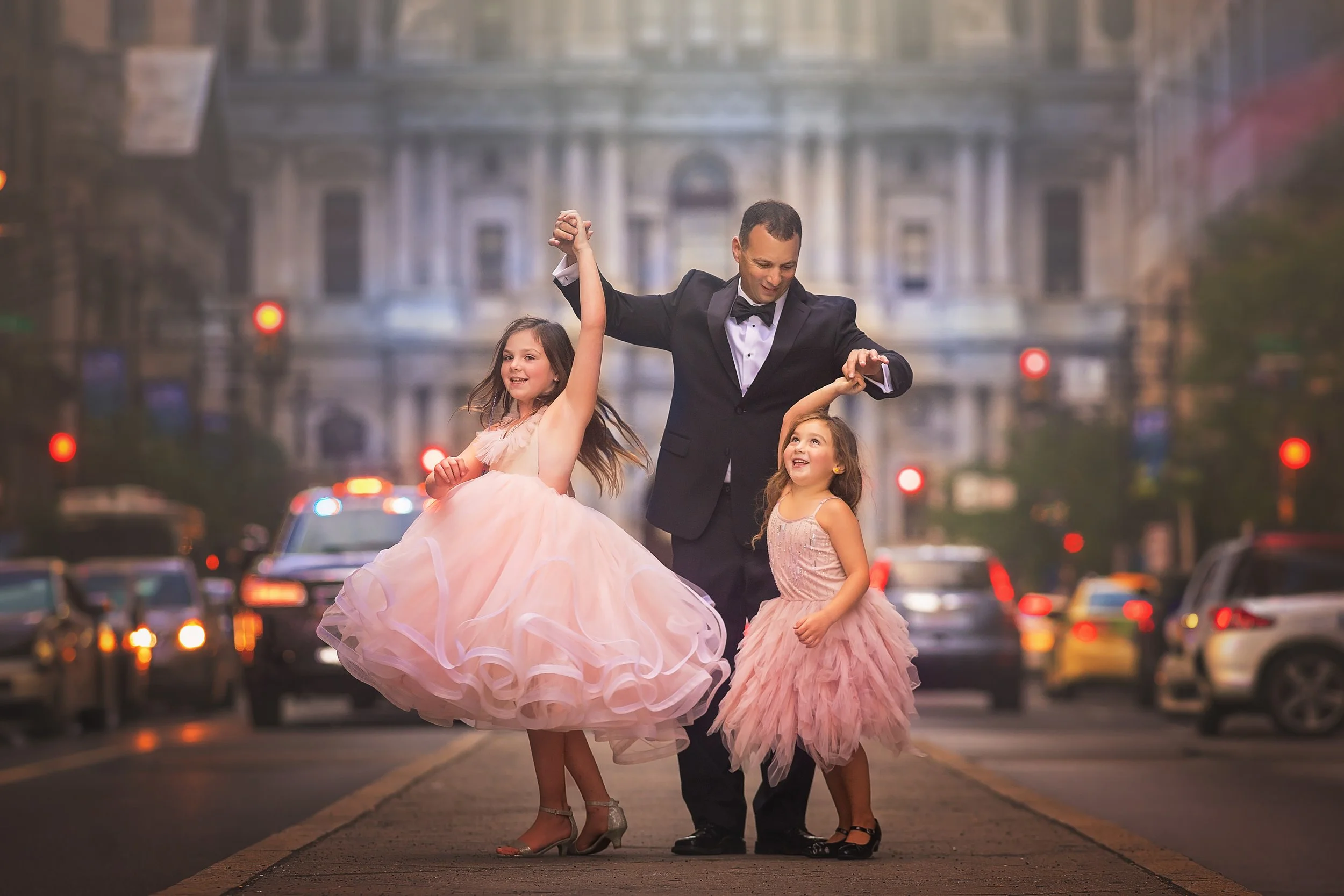 dad twirling his two girls for a philadelphia portrait session