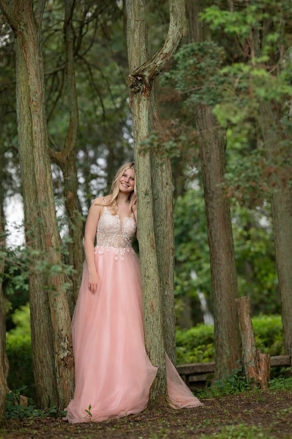 high school senior girl posing near trees during outdoor senior portrait session in South Jersey near Philadelphia