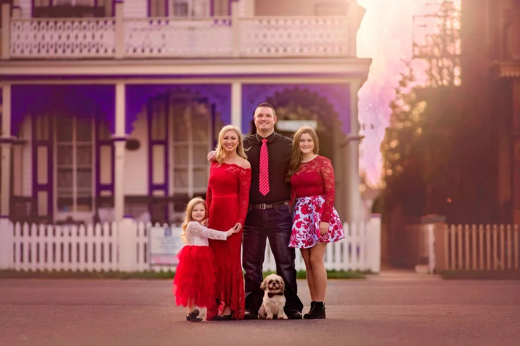 Family portraits in front of historic Victorian cottages in Cape May New Jersey photographed by a Jersey Shore family photographer.