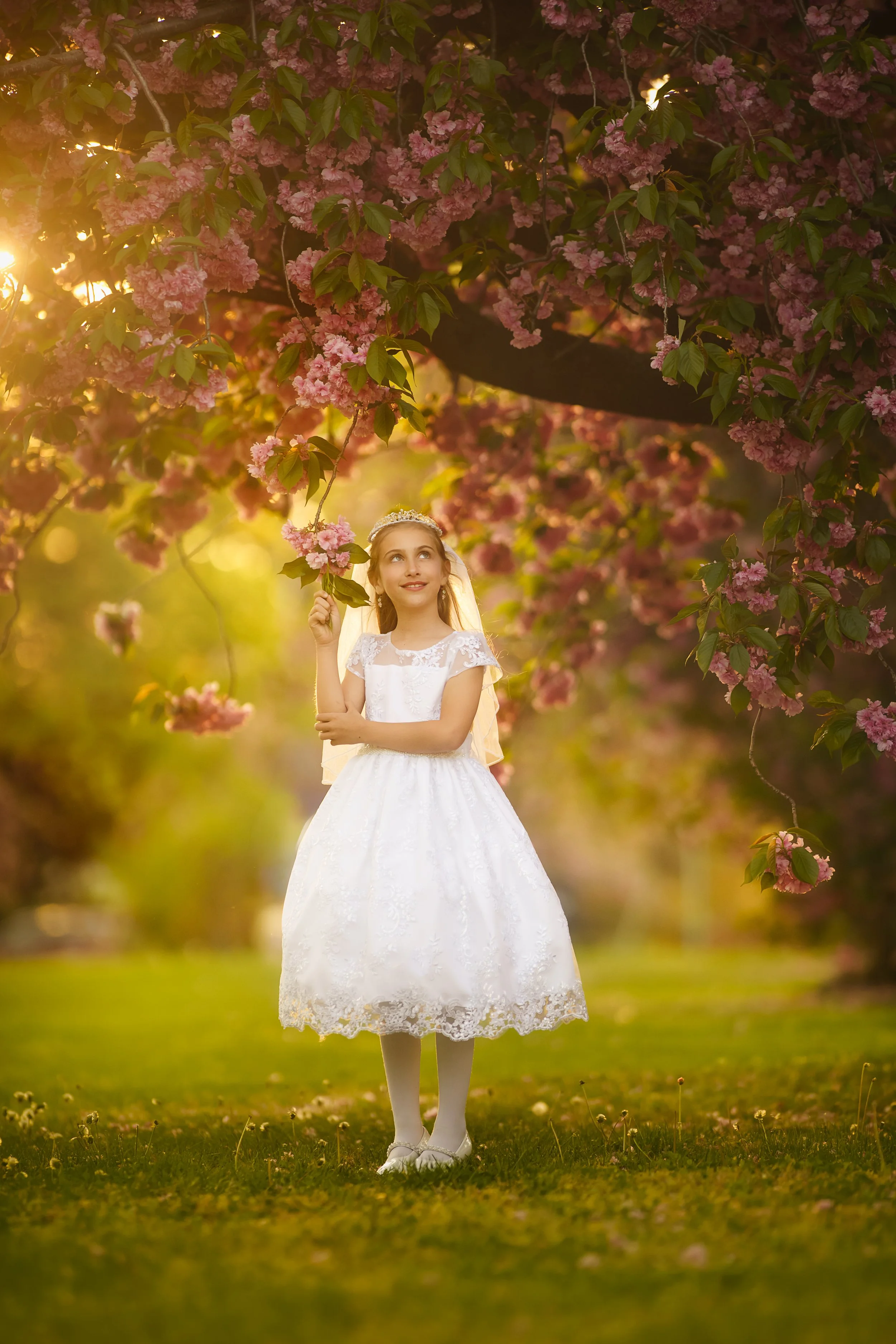 girl in cherry blossoms for first holy communion portraits taken in Cherry Hill, New Jersey