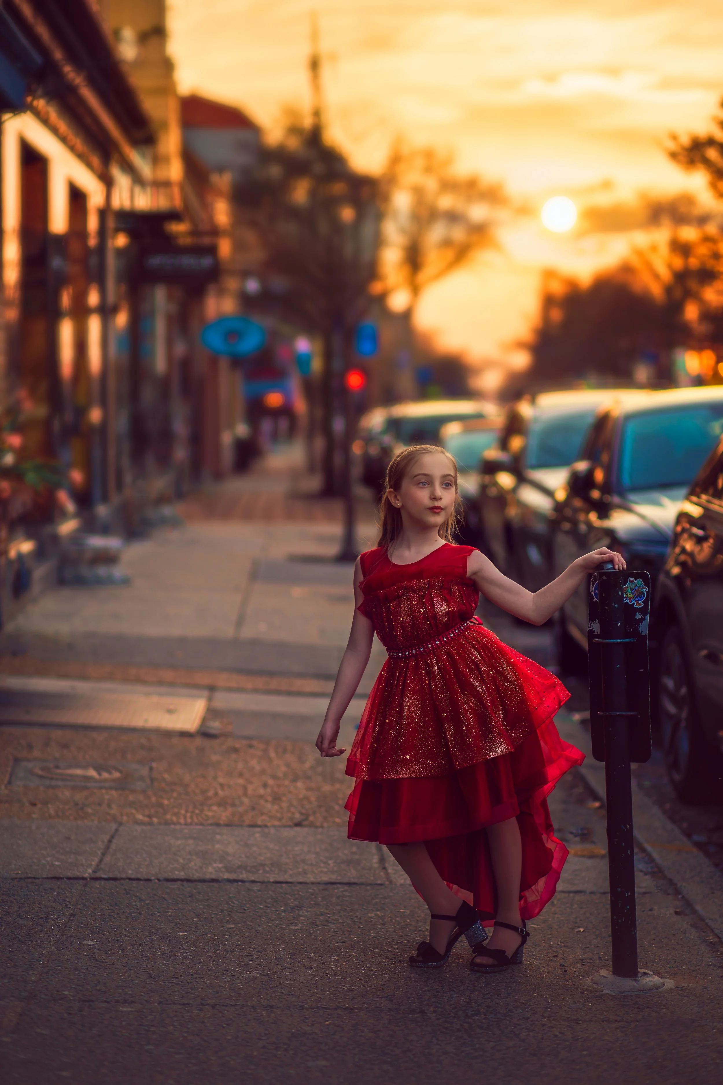 Girl in red dress walking through downtown Collingswood NJ during sunset child portrait session