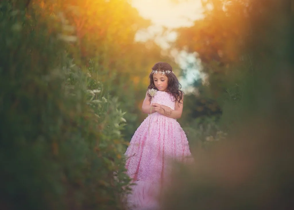 Girl posing for her portrait at the bay in Cape May, New Jersey, wearing a pink dress during her birthday photo session with a local Cape May photographer.
