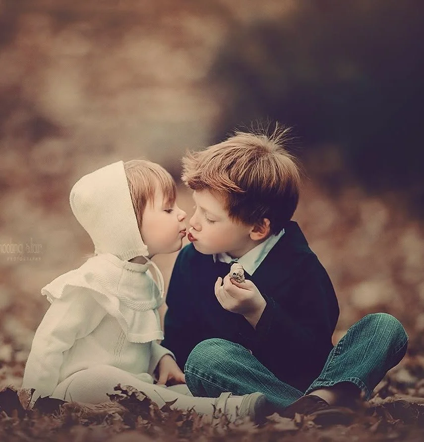 Close-up portrait of young siblings sharing a quiet, emotional moment during a fine art family session in South Jersey.
