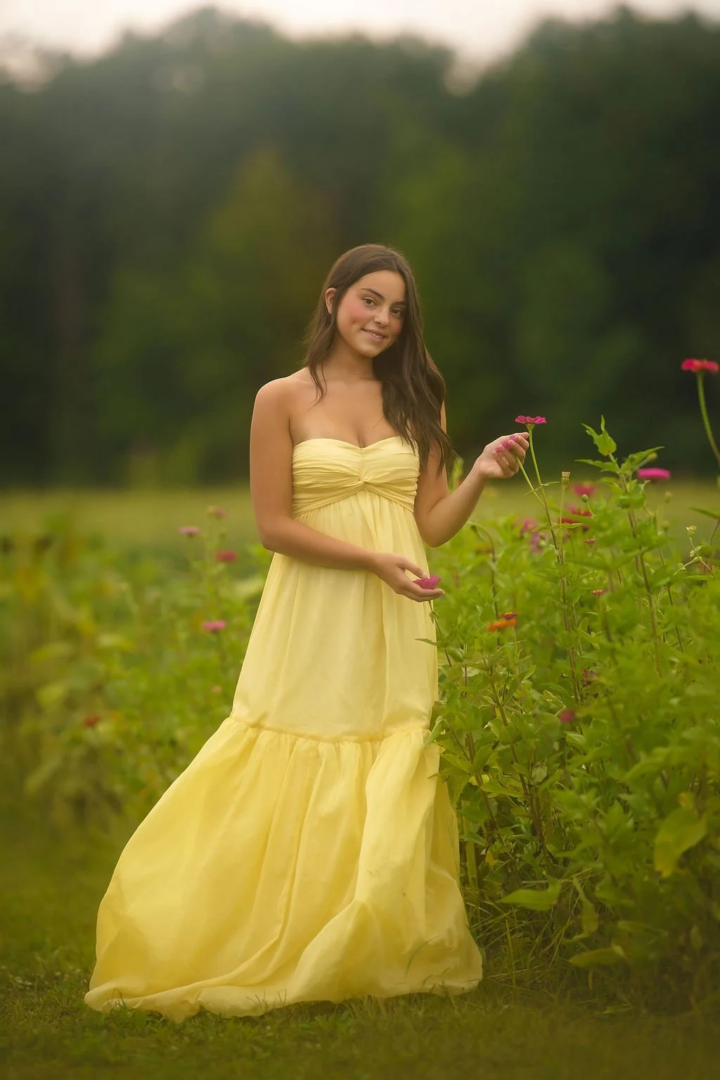 Teen girl wearing a flowing yellow dress during a soft, feminine outdoor senior portrait session in South Jersey.