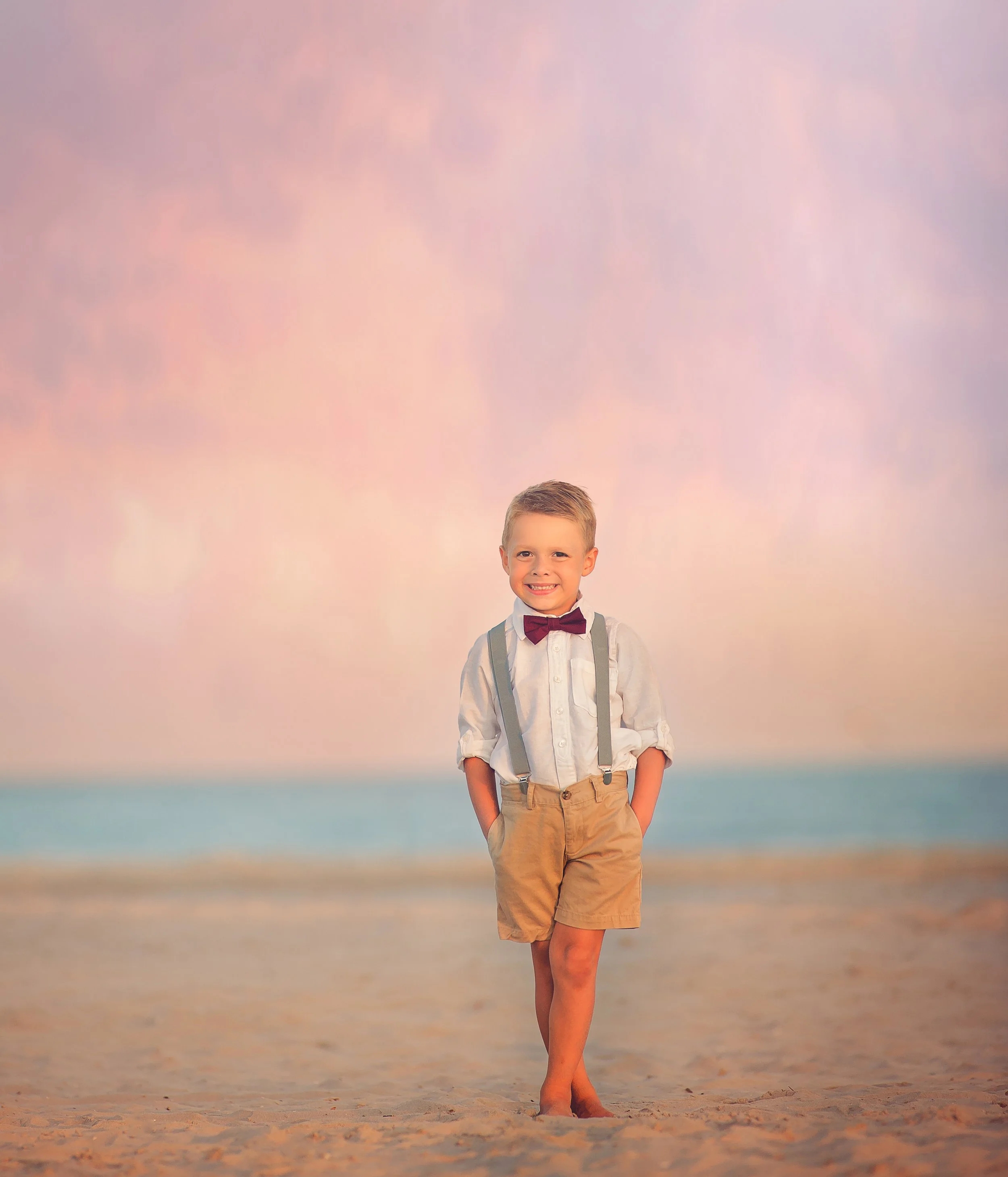 Child standing near the shoreline during a Wildwood NJ beach photography session captured by a South Jersey photographer.