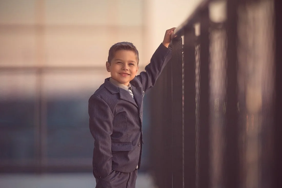 Close-up portrait of a young boy with soft light and a calm expression, photographed at Cira Green in Philadelphia.