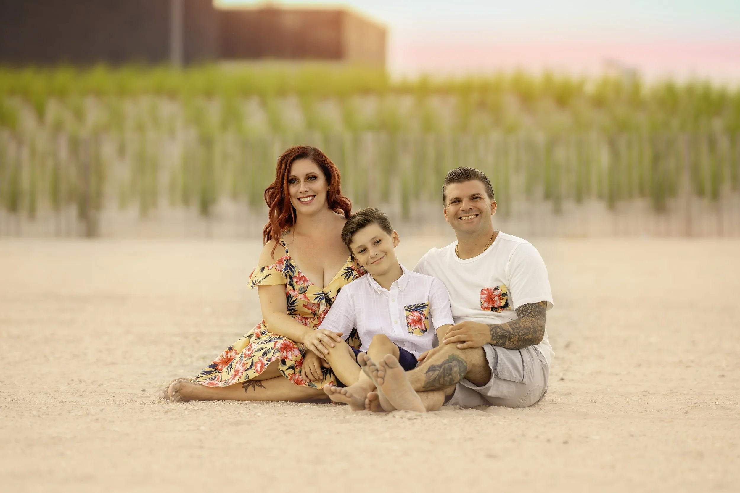 Family posing together near the sand dunes during a Cape May family portrait session