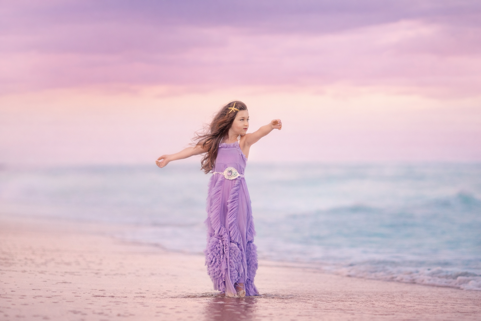 girl standing on the beach with wind blowing through her hair during sunset in Ocean City NJ