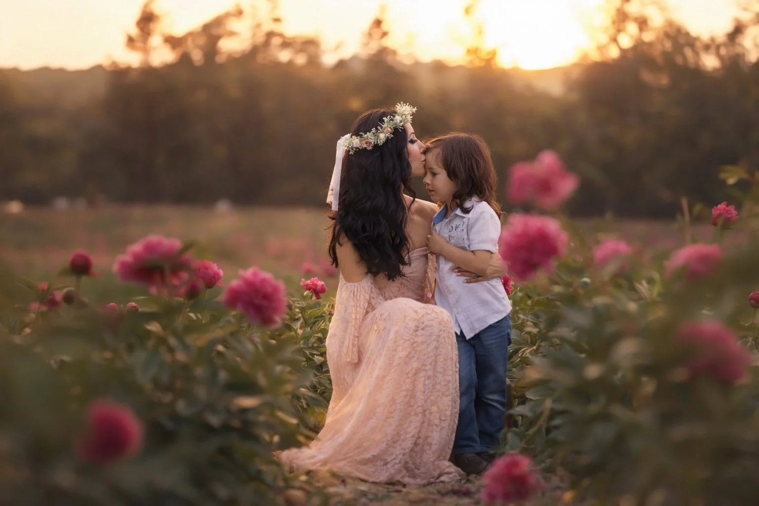 Mother kissing young son in peony field during South Jersey family portrait session