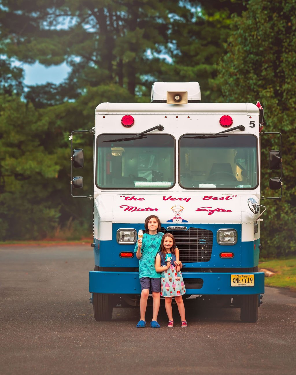 Brother and sister holding hands while enjoying their ice cream cones in Sewell, NJ.