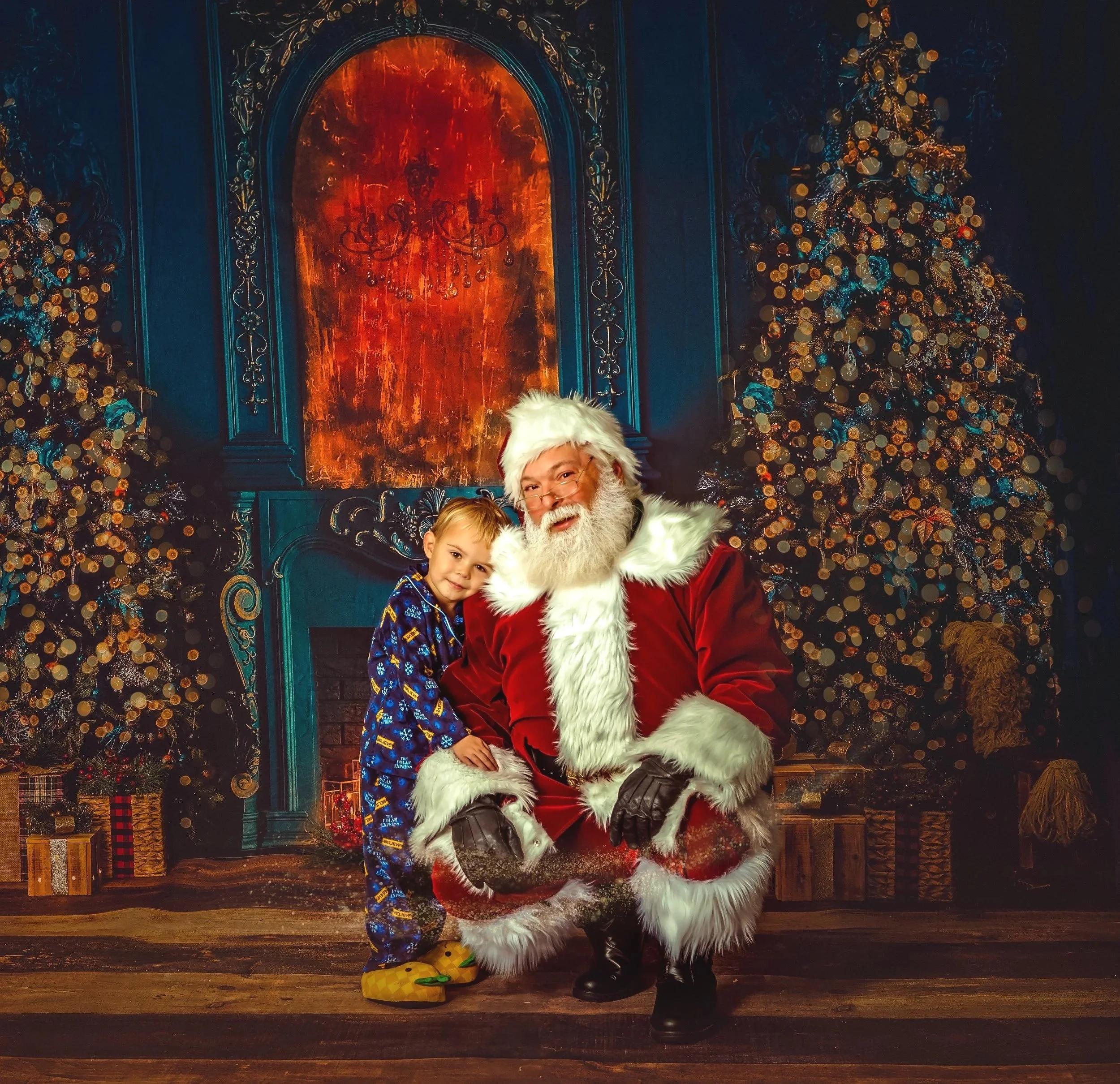 A young boy in pajamas enjoying a gentle, fine-art Santa Claus portrait session filled with quiet Christmas magic.