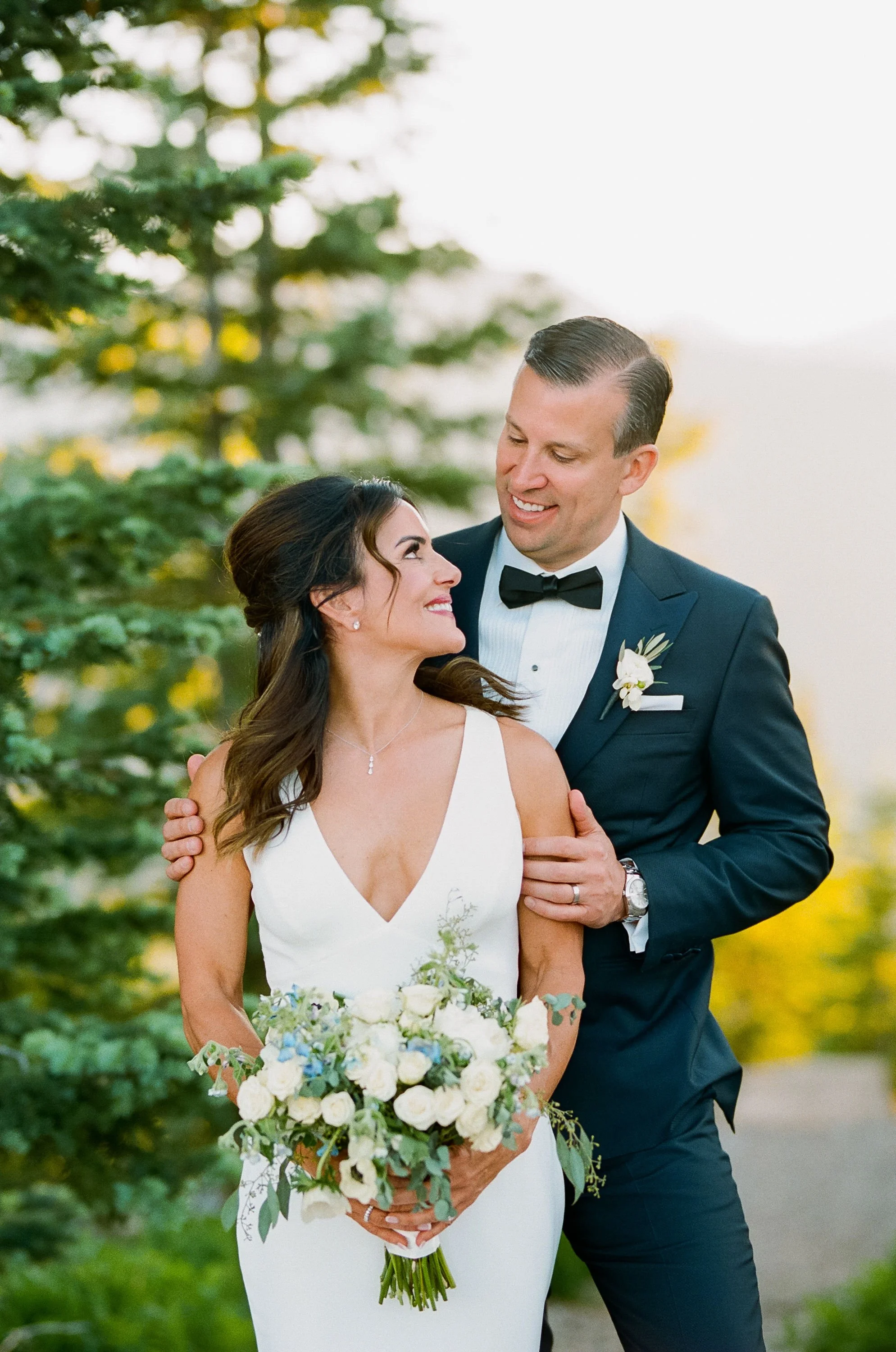 Alaska bride and groom portraits with pine trees