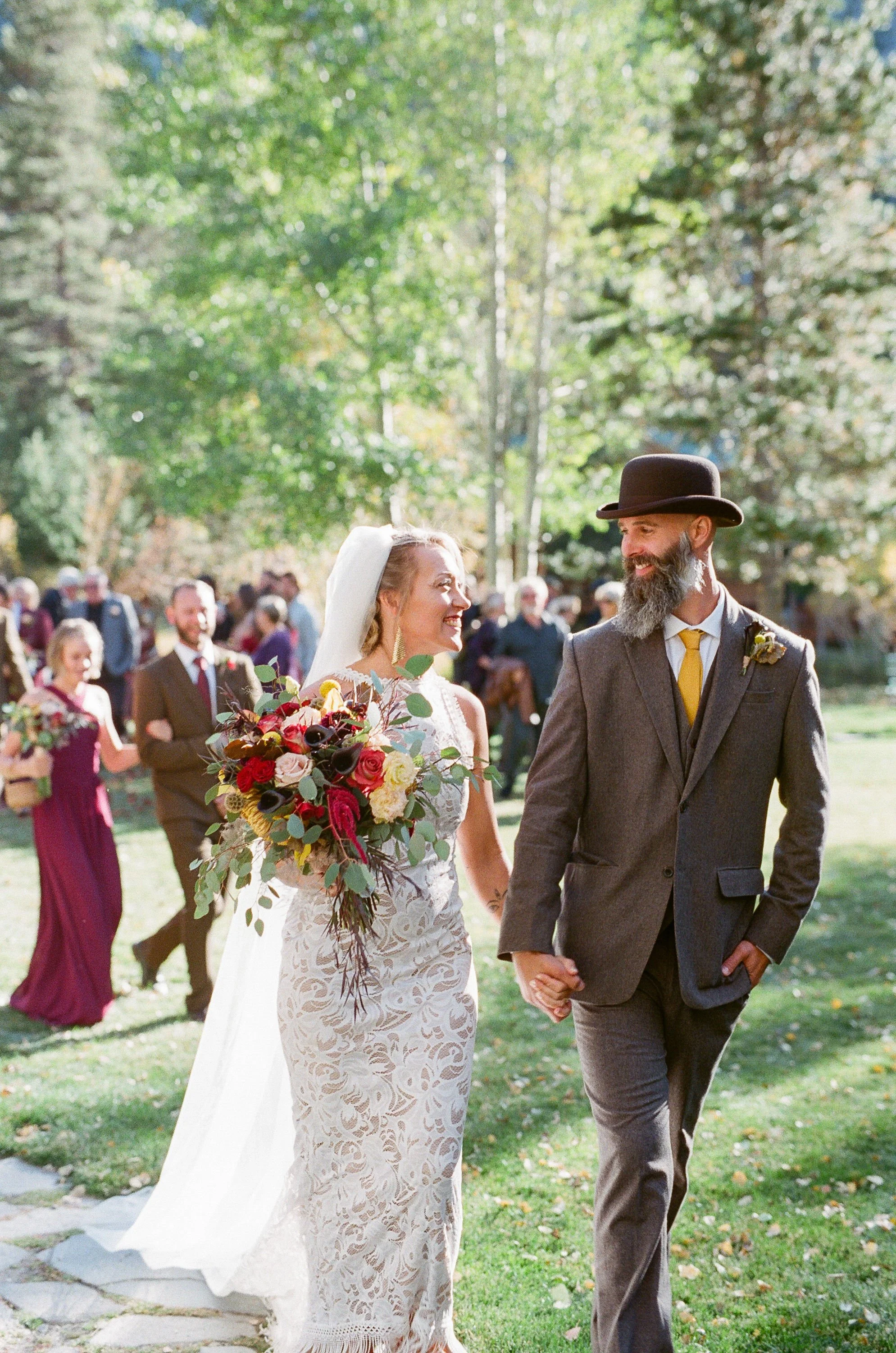Alaska bride and groom walking away from wedding ceremony
