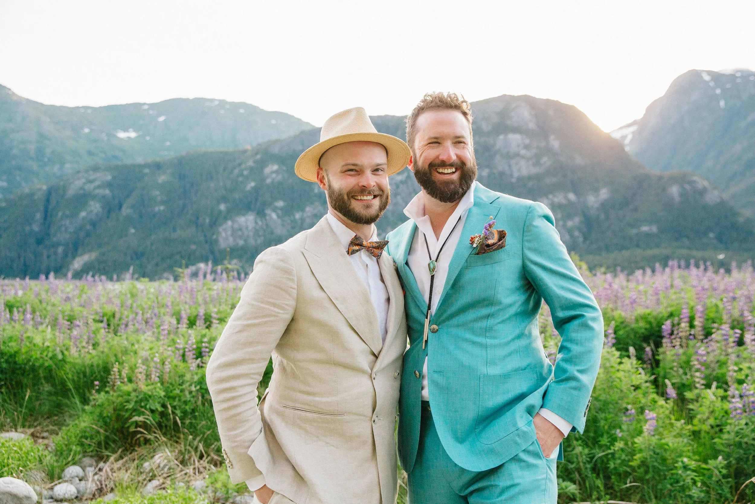 Portrait of two grooms in lupine field southeast alaska