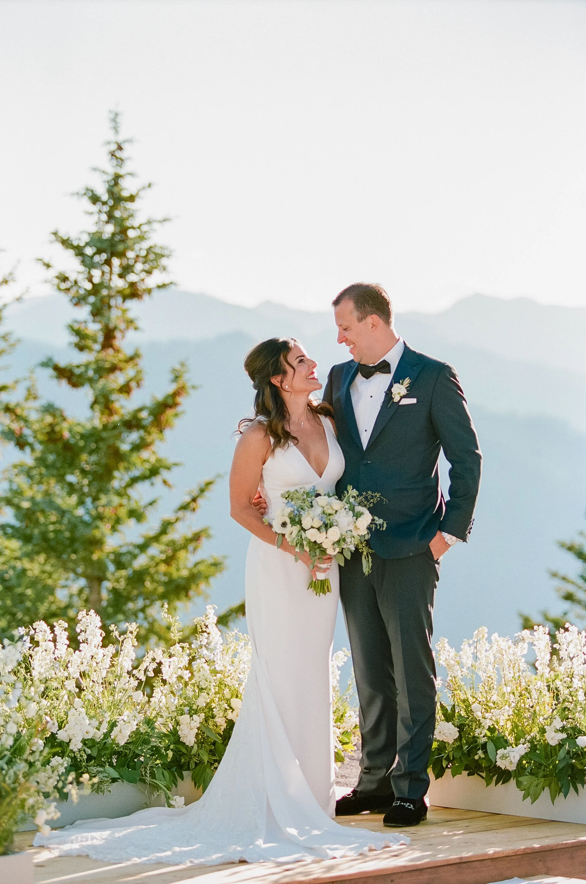 Alaska Bride and Groom portrait on mountaintop with pine trees