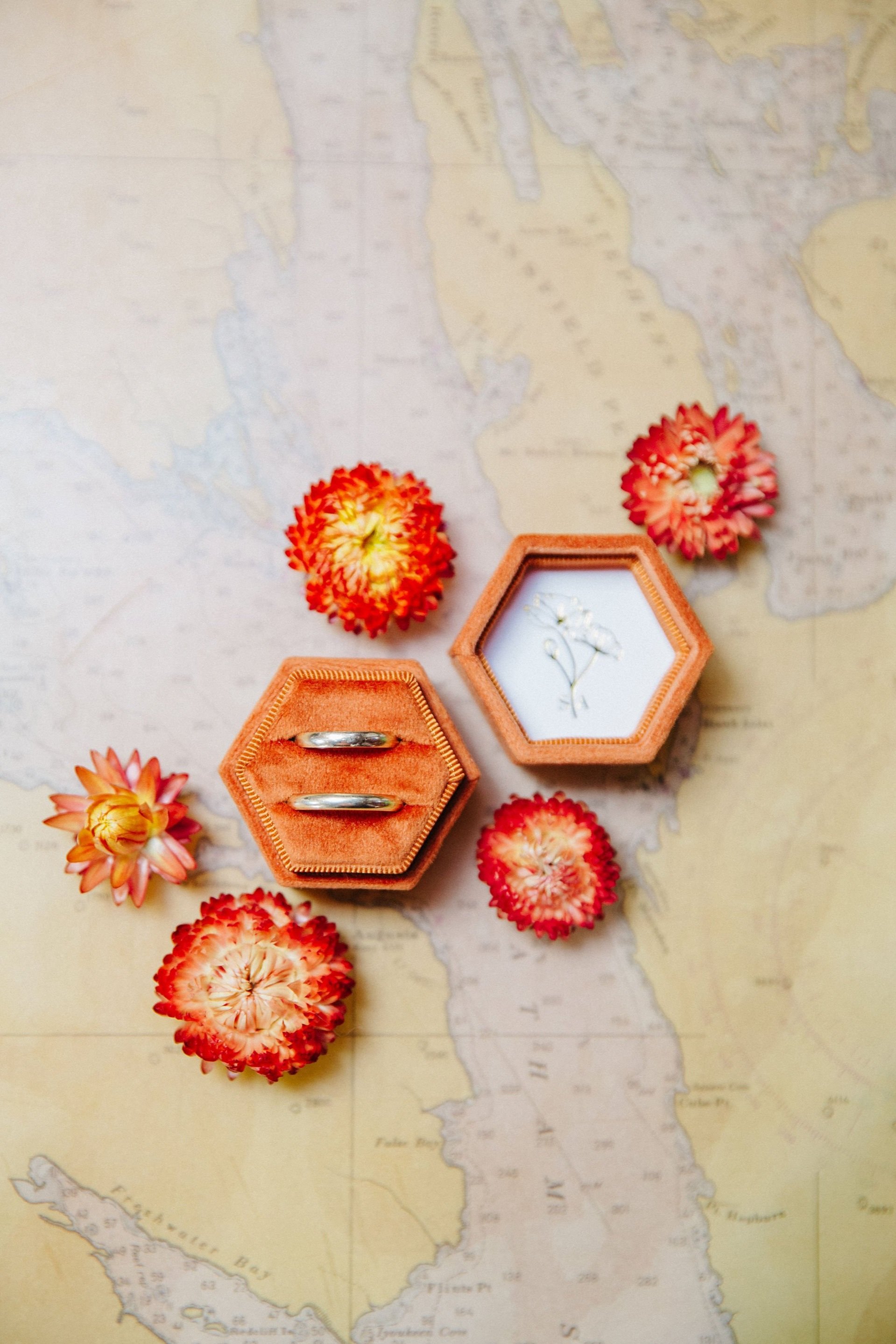 Wedding rings detail photograph flatlay with dried flowers
