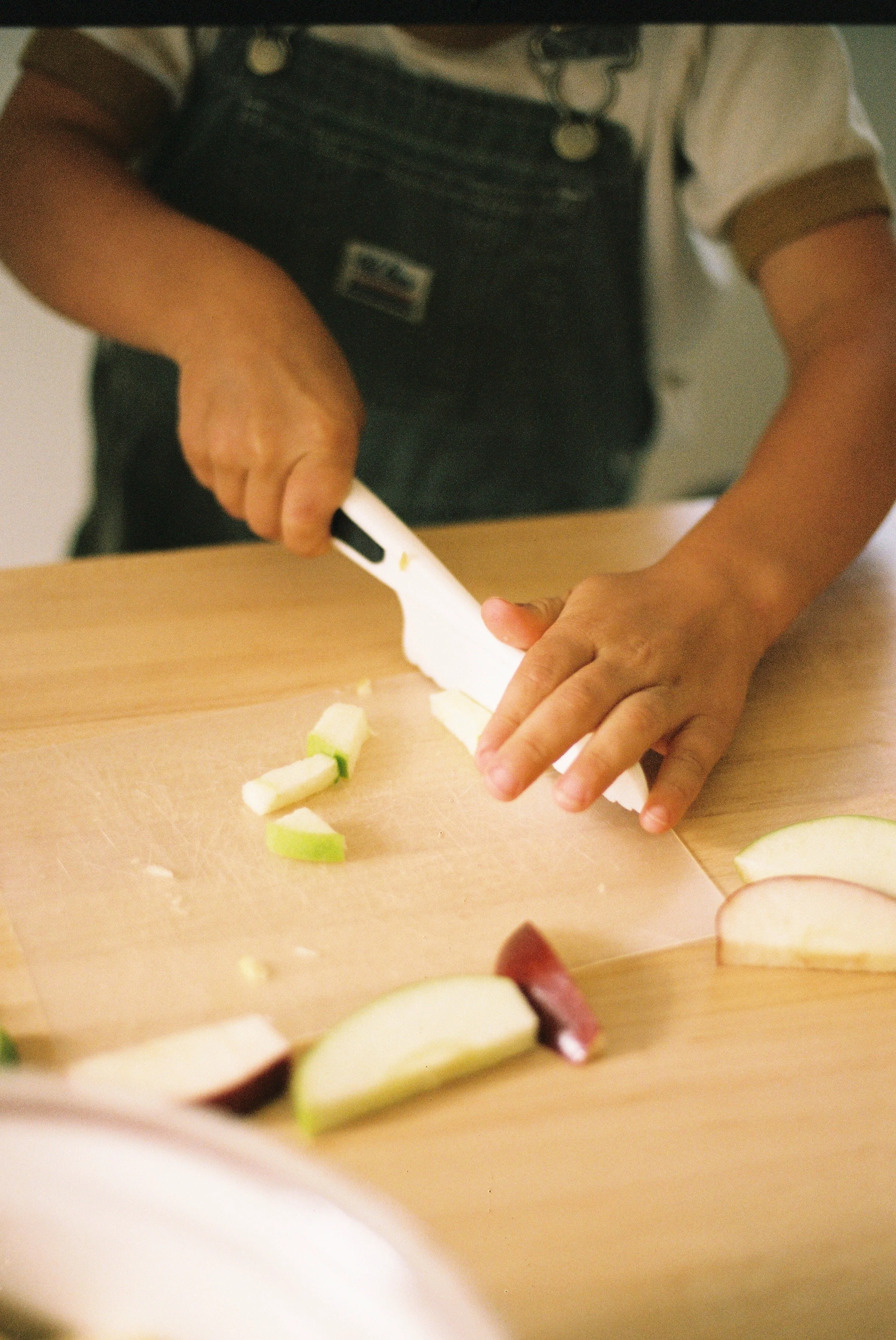 A child cutting apples.