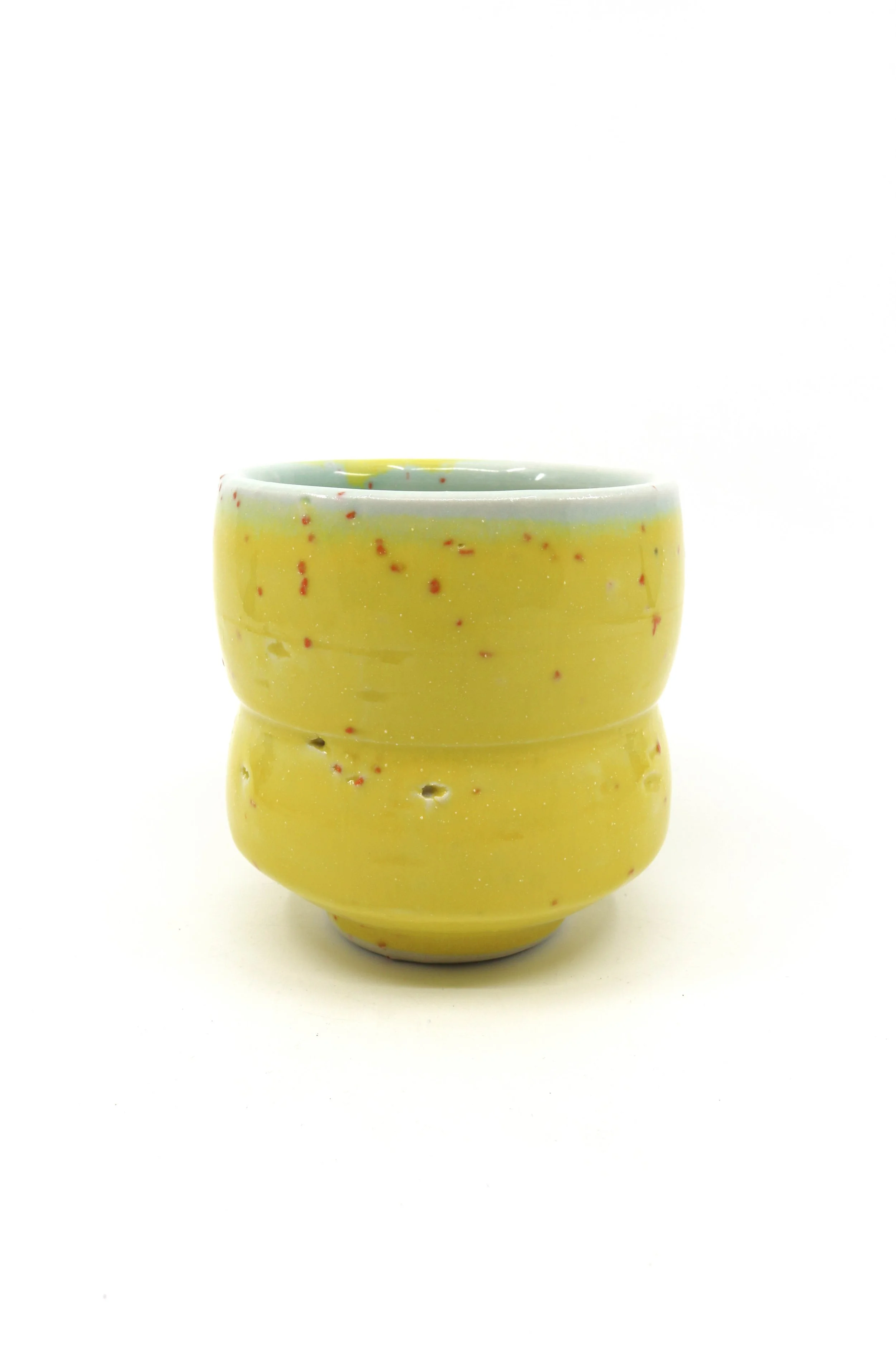 Autumn L wedged into thrown porcelain with transparent glazes. 