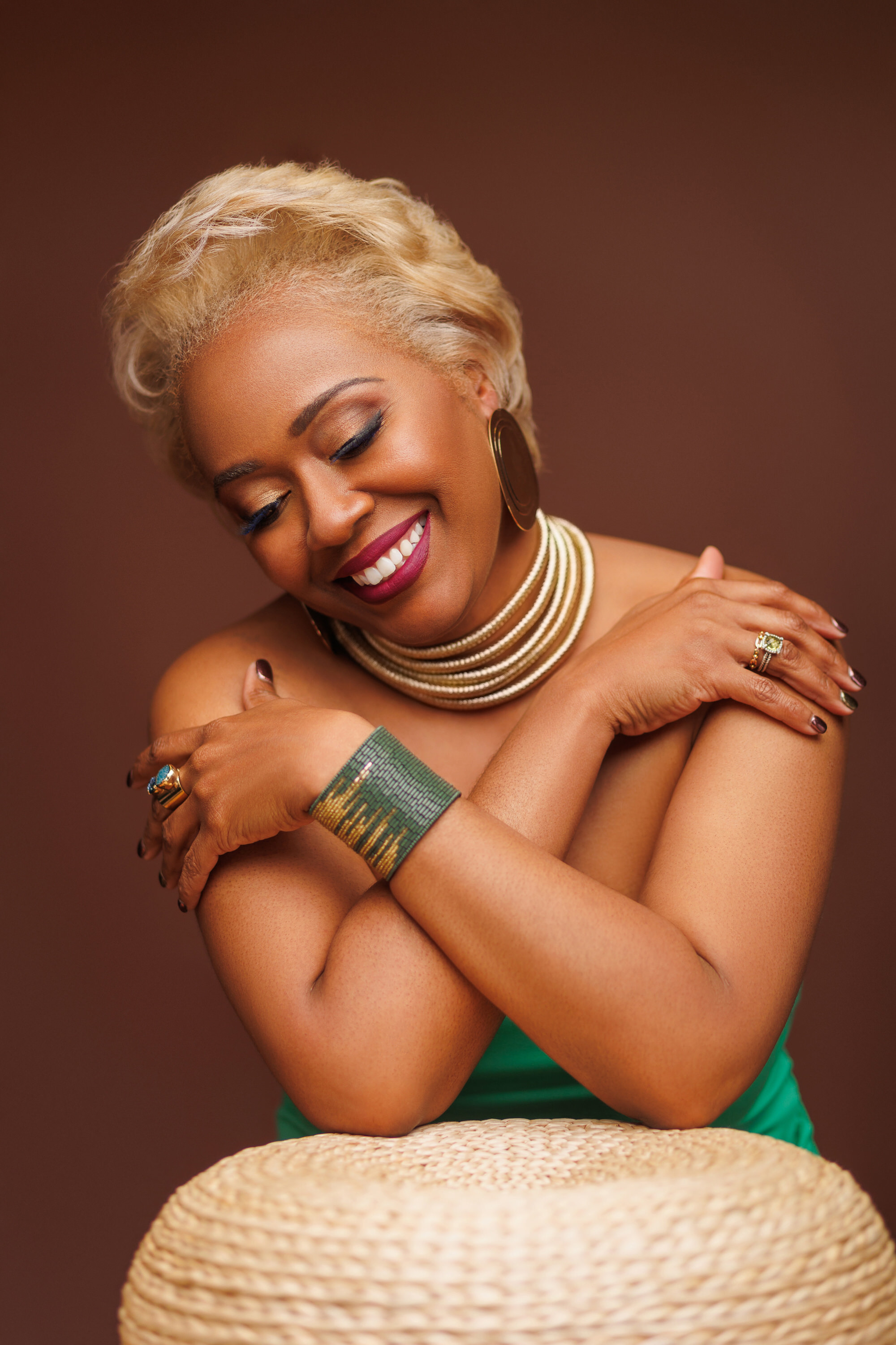 Woman Laughing in a a photoshot wearing green with red lips and blond hair african american photoshoot memphis tennesse
