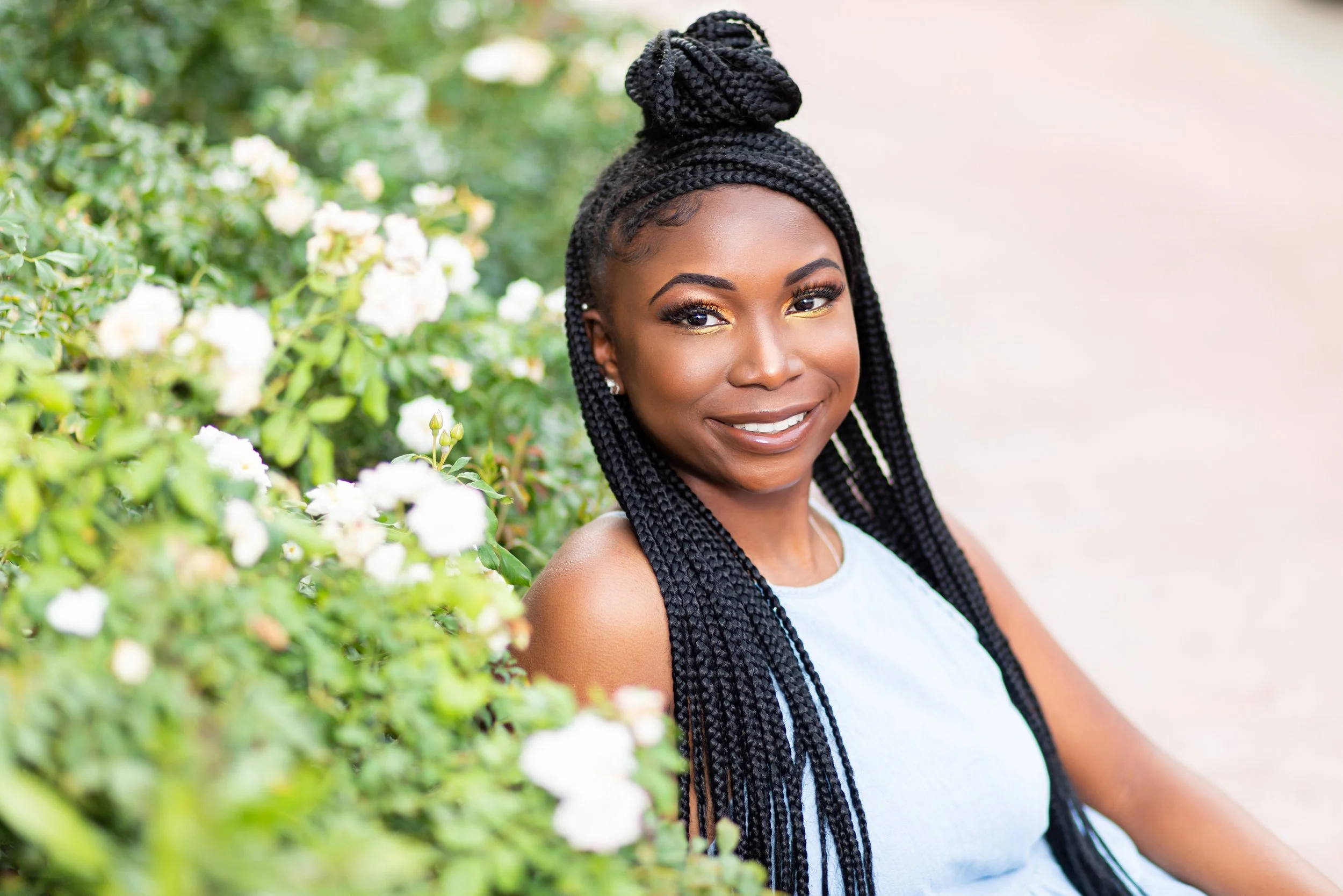 outdoor senior photoshoot of a smiling high school senior with long braided hair photographed by hadonicas photography in memphis tennessee. High school senior photographer. Outdoor Senior photography in memphis tennessee