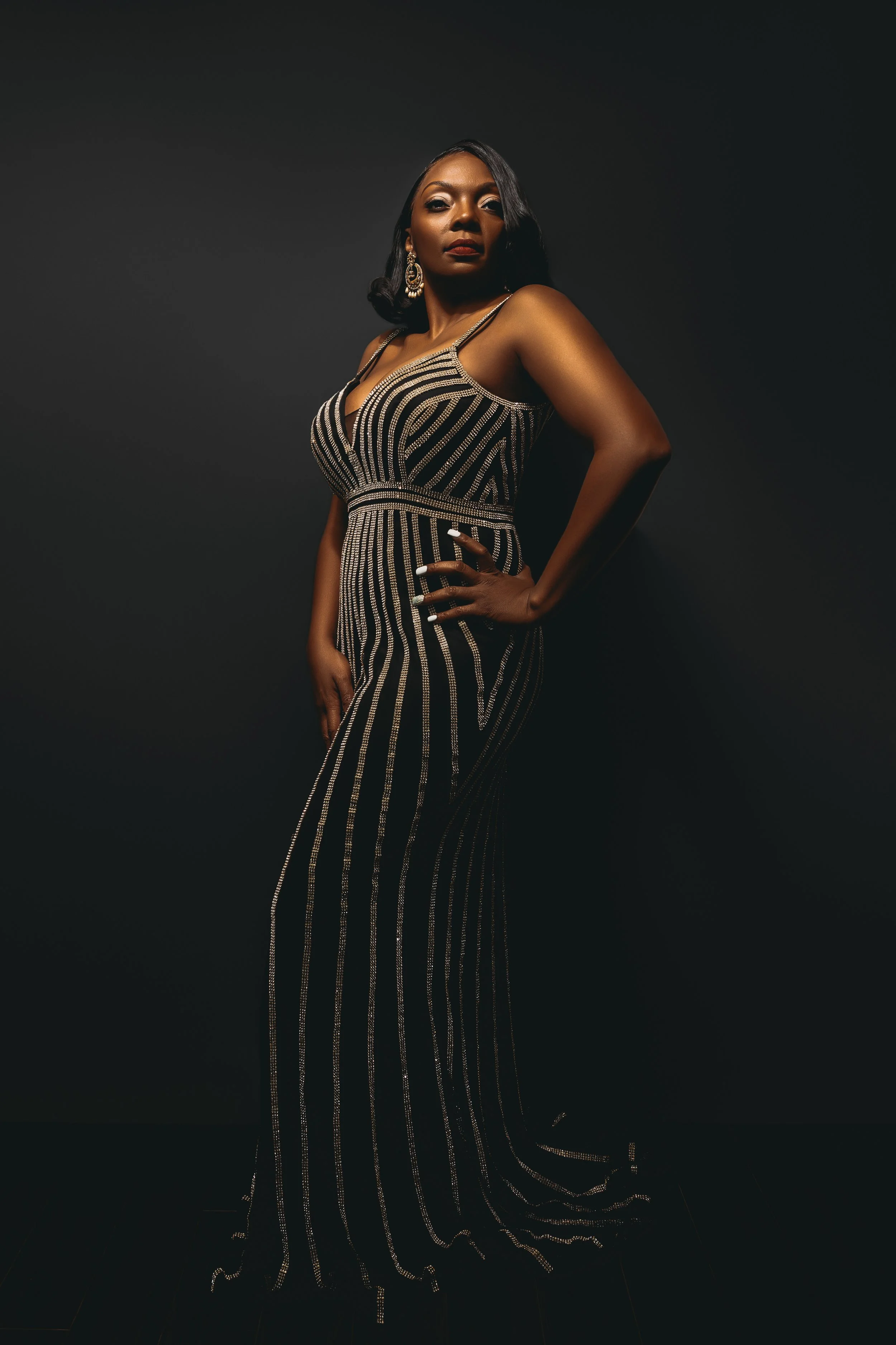 Luxury Empowered 30+ portrait of a confident woman in an evening gown, photographed in a Memphis Tennessee studio by Hadonica’s Photography.