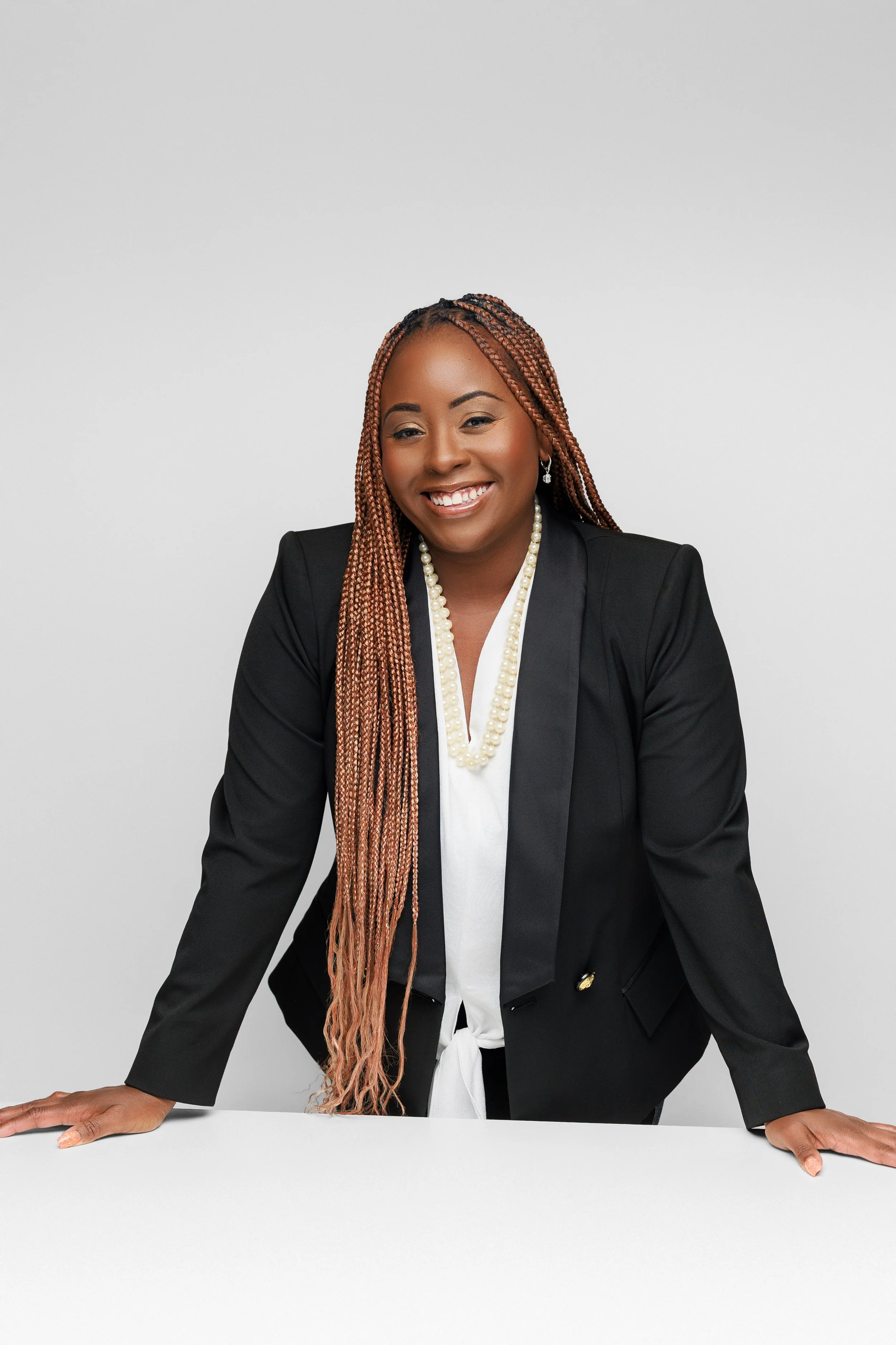 Personal branding portrait of a confident woman in a black blazer, photographed in a Memphis Tennessee studio by Hadonica’s Photography.