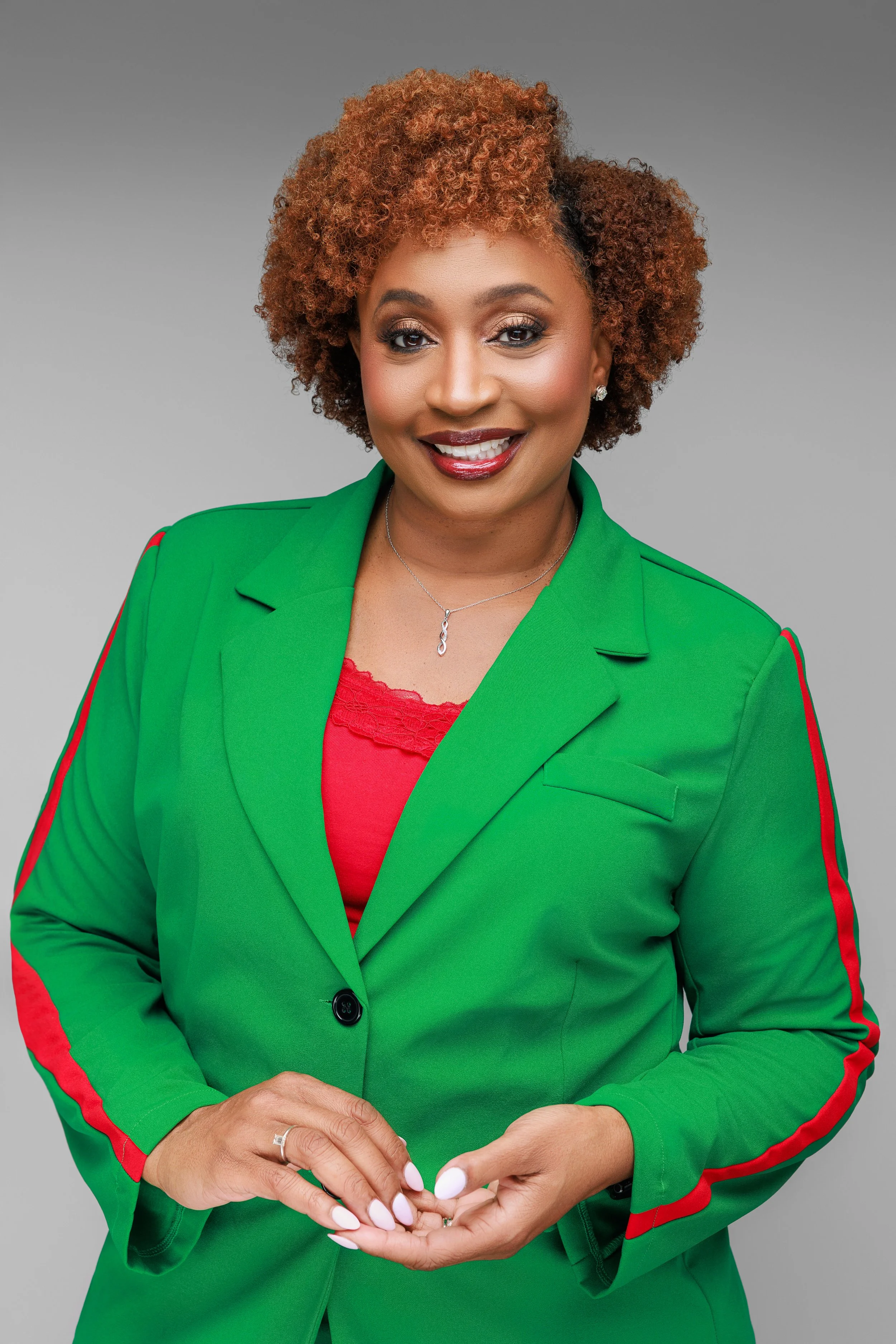 Elegant empowered portrait of woman in green blazer photographed in Memphis Tennessee studio