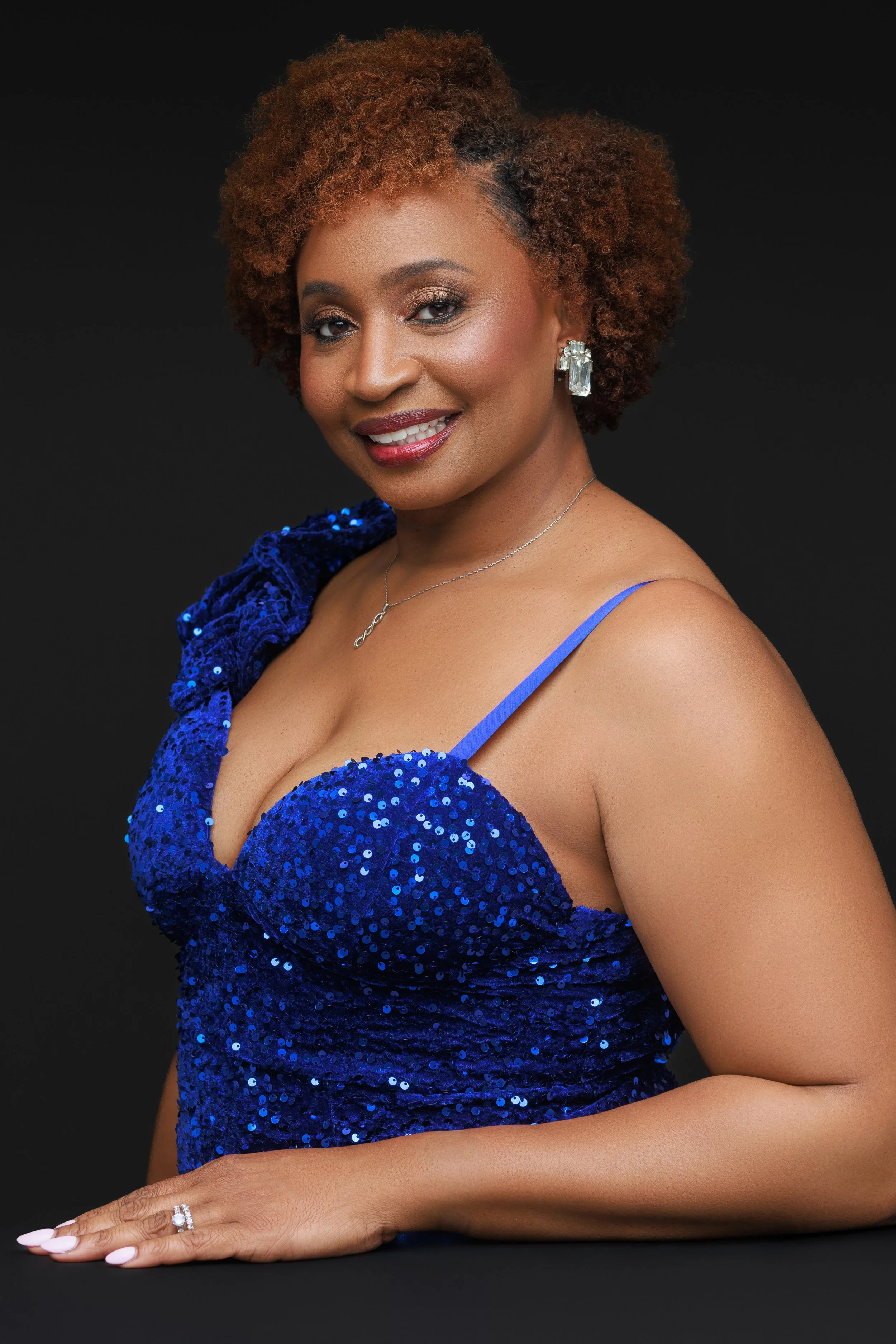 Elegant side portrait of woman in royal blue gown photographed at Memphis portrait studio