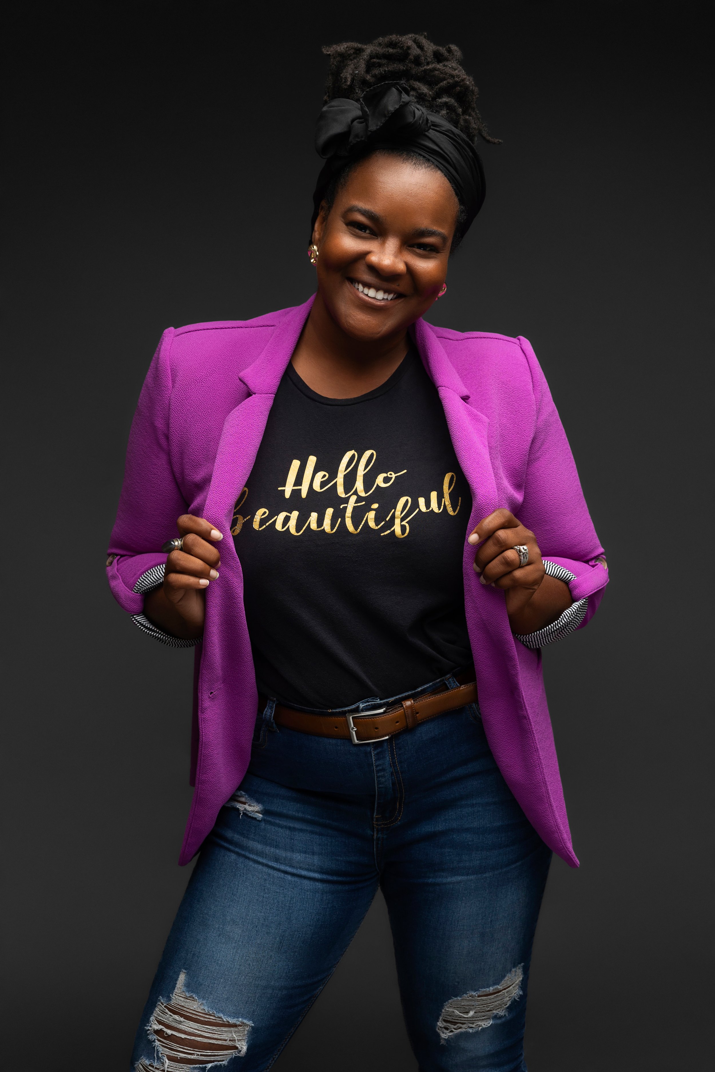 Empowering personal branding portrait of a confident black woman smiling in a purple blazer and "hello beautiful" shirt photographed by Hadonica's Photography in Memphis Tennessee

Confident studio of a joy woman celebrating self love and empowerment