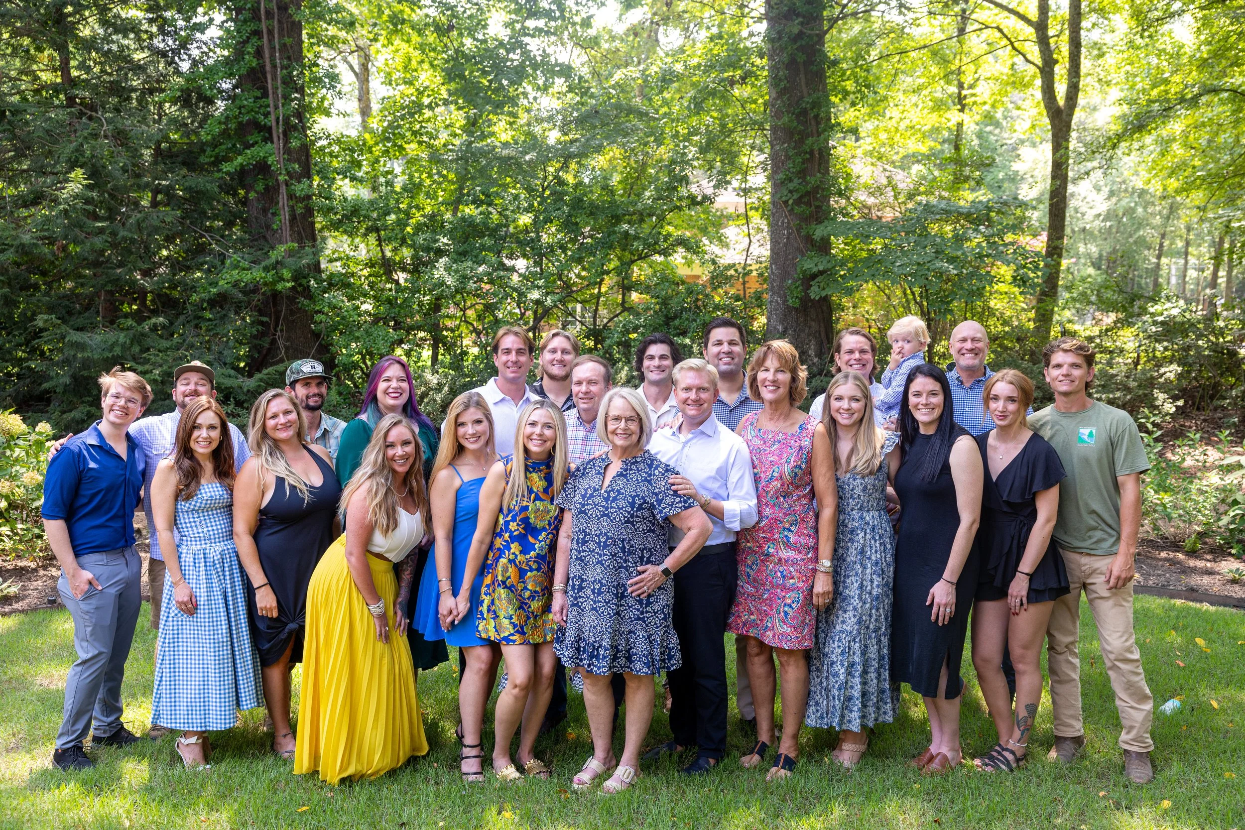 Large extended family group portrait outdoors in a garden setting in Memphis Tennessee