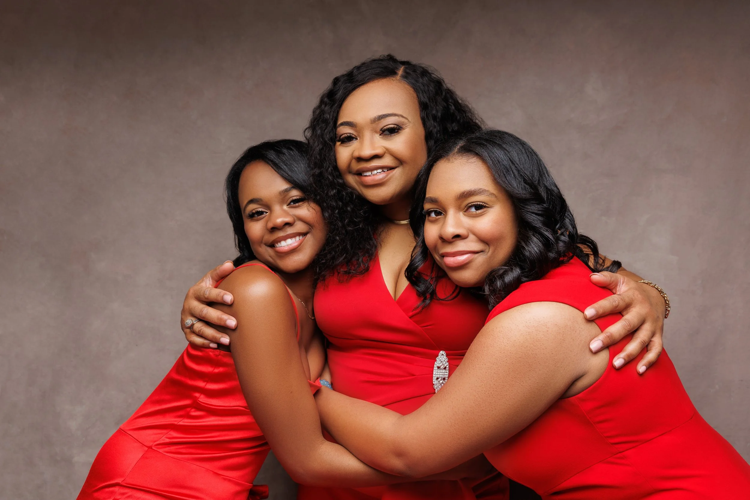 Mother and daughters hugging during a family photoshoot in Memphis TN studio