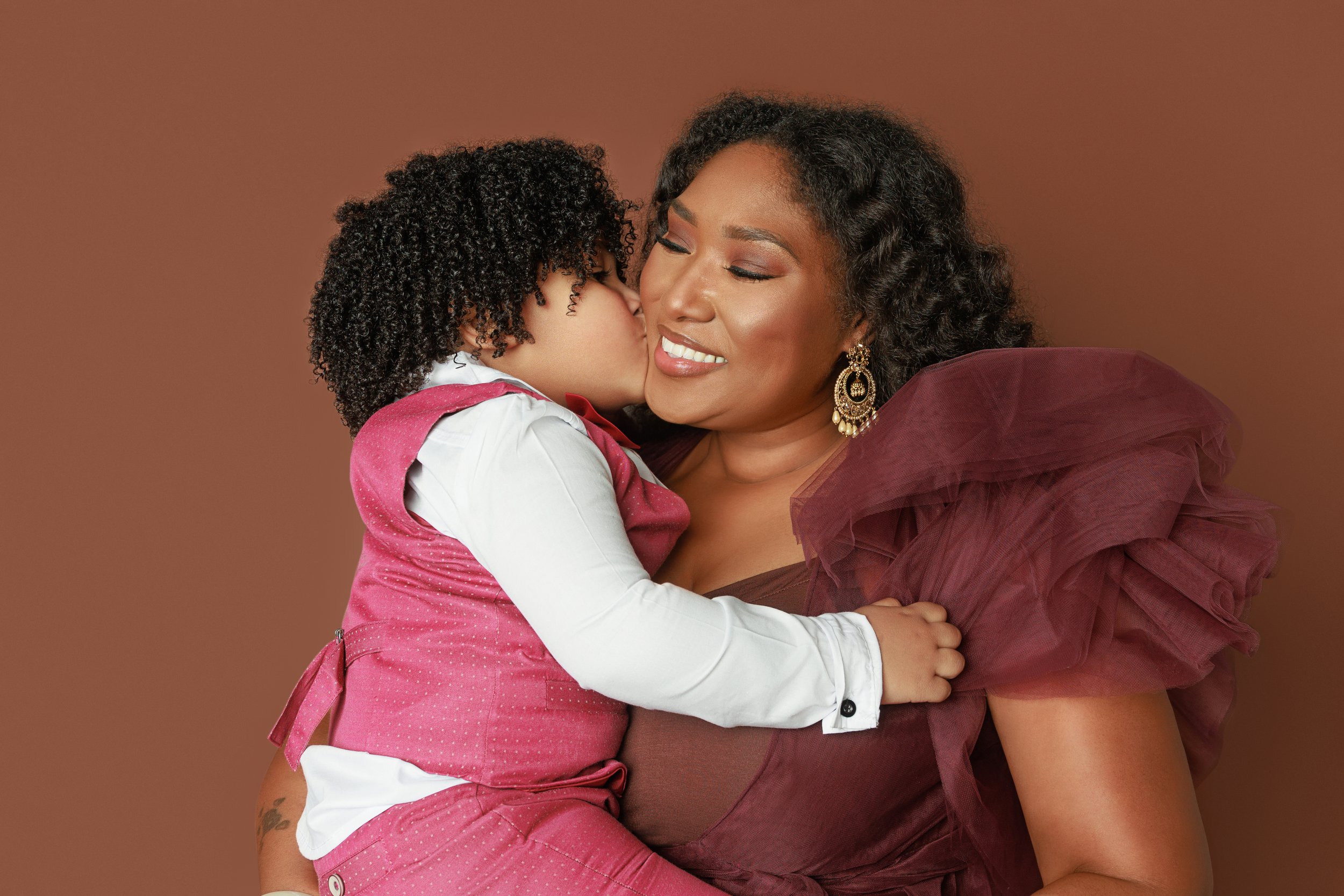 Elegant studio portrait of mother embracing her young son, photographed at Hadonica’s Photography in Memphis Tennessee, specializing in luxury family and motherhood portraits