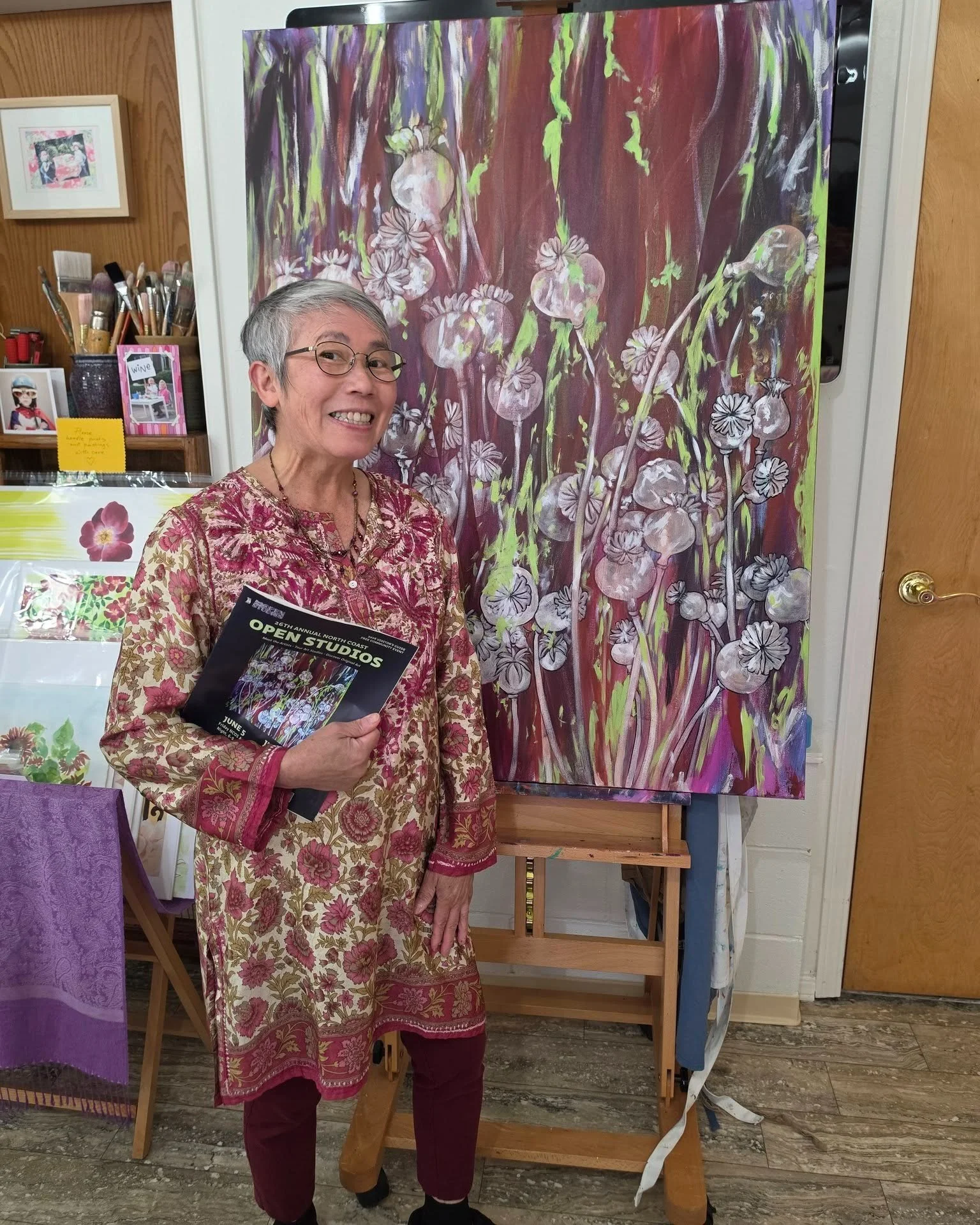 Painter Thao Le Khac @thao.le.khac  poses with the painting of poppy pods that became the cover image for the 2026 North Coast Open Studios guidebook, in her Arcata studio.

NCOS Weekend 2 runs next Saturday and Sunday from 10am to 5pm. Check your lo
